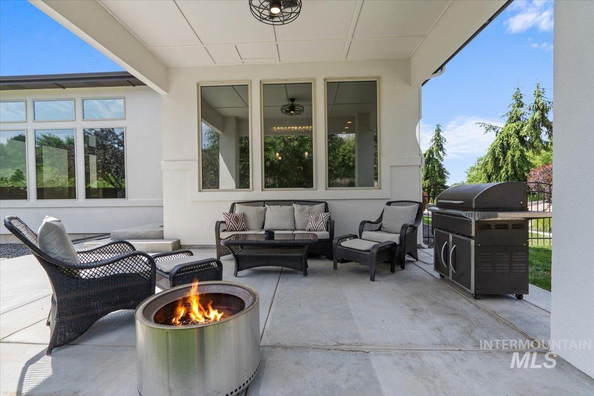 View of patio / terrace with an outdoor living space with a fire pit and grilling area