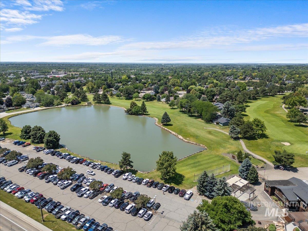 Drone / aerial view of a nearby body of water and a local golf course
