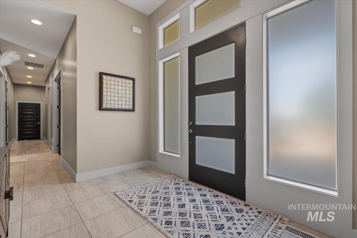 Entryway with recessed lighting and light tile patterned floors