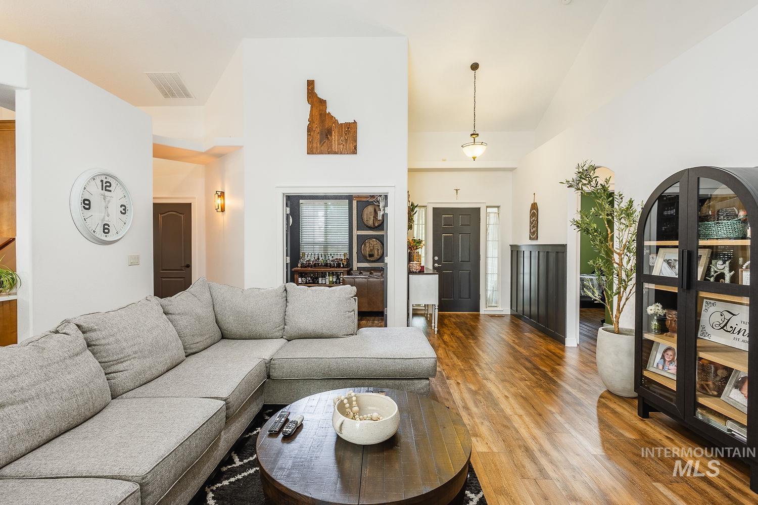 Living area featuring wood finished floors and high vaulted ceiling