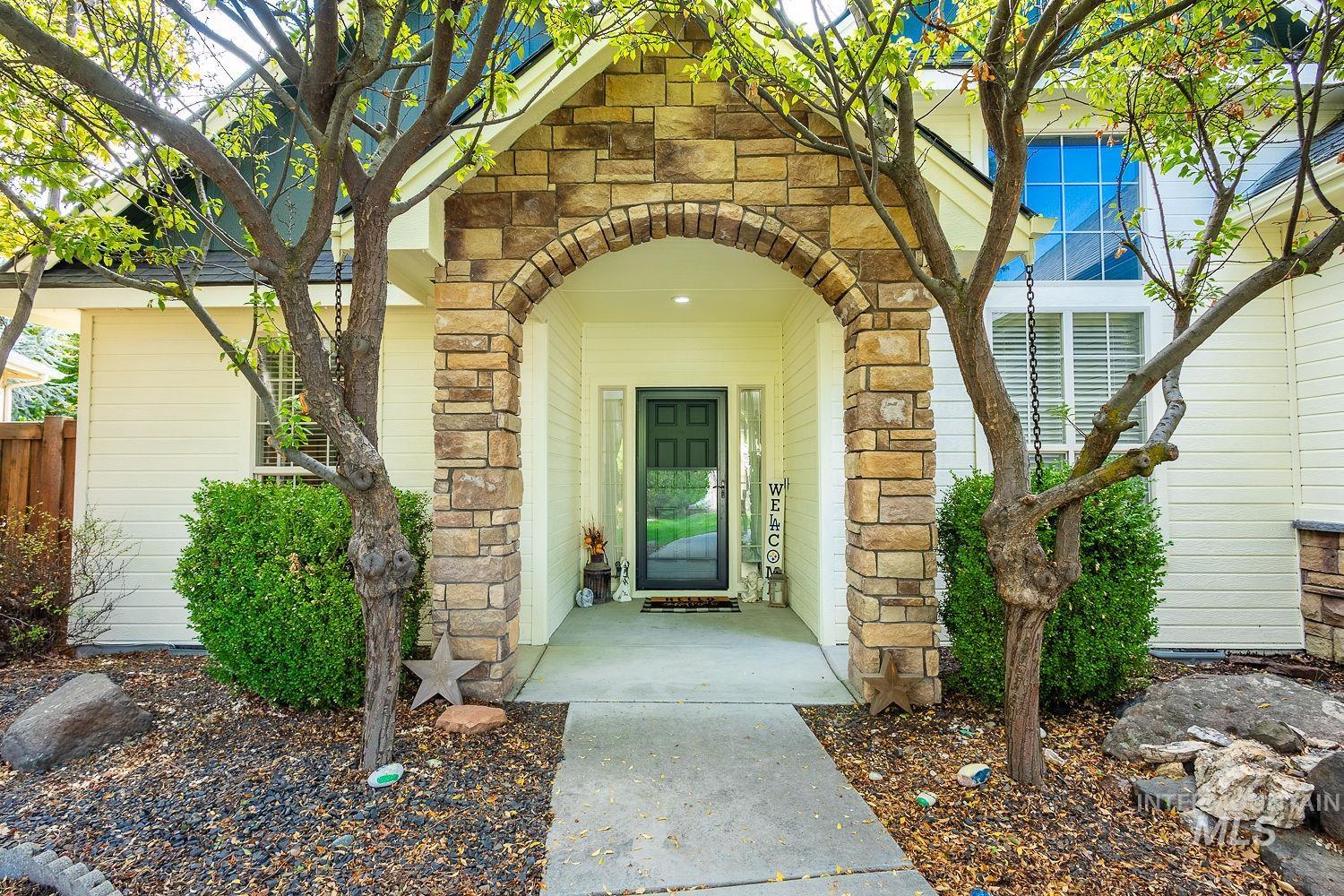 Entrance to property with stone siding