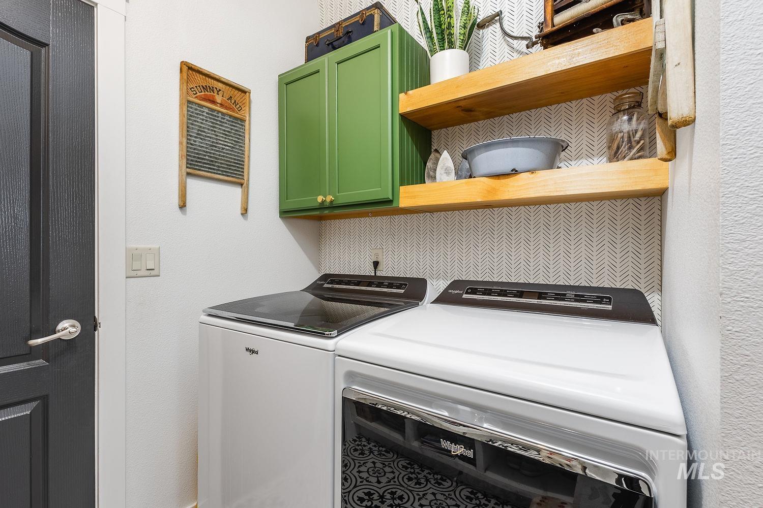 Laundry area with washer and clothes dryer and cabinet space