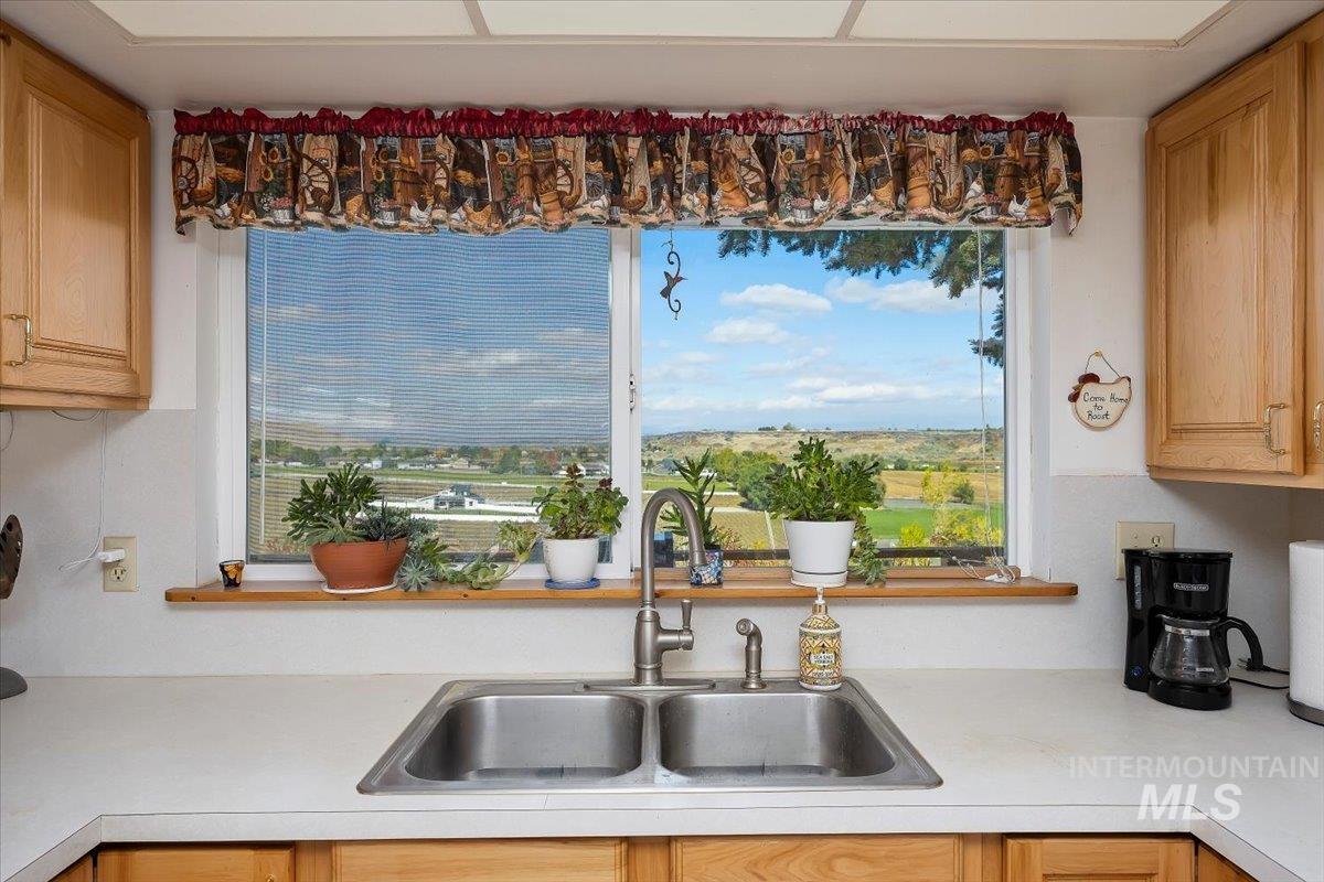 Kitchen with light countertops, healthy amount of natural light, and light brown cabinetry