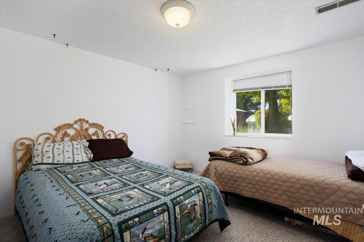 Carpeted bedroom featuring a textured ceiling