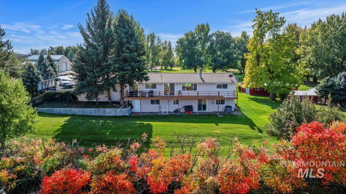 Rear view of property featuring a lawn