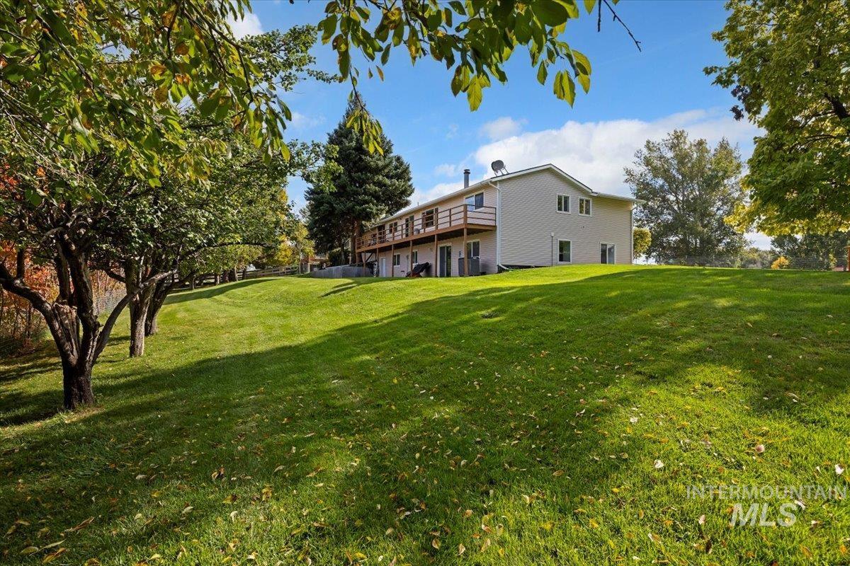 View of green lawn featuring a deck