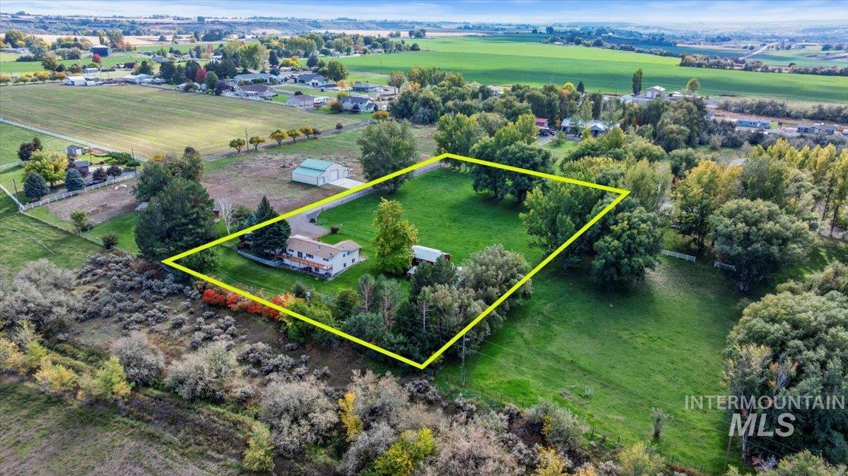 Aerial view of sparsely populated area featuring property parcel outlined