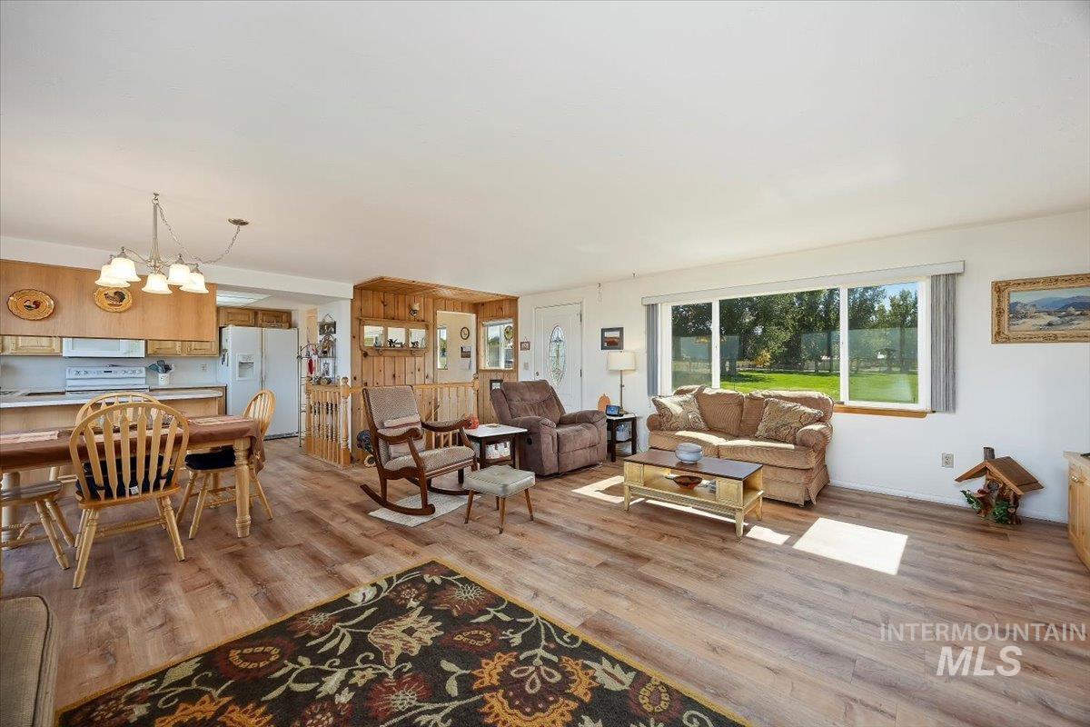Living area with light wood finished floors and a chandelier