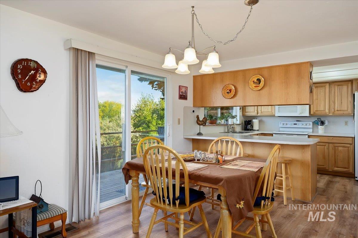 Dining room featuring light wood-style flooring and a chandelier