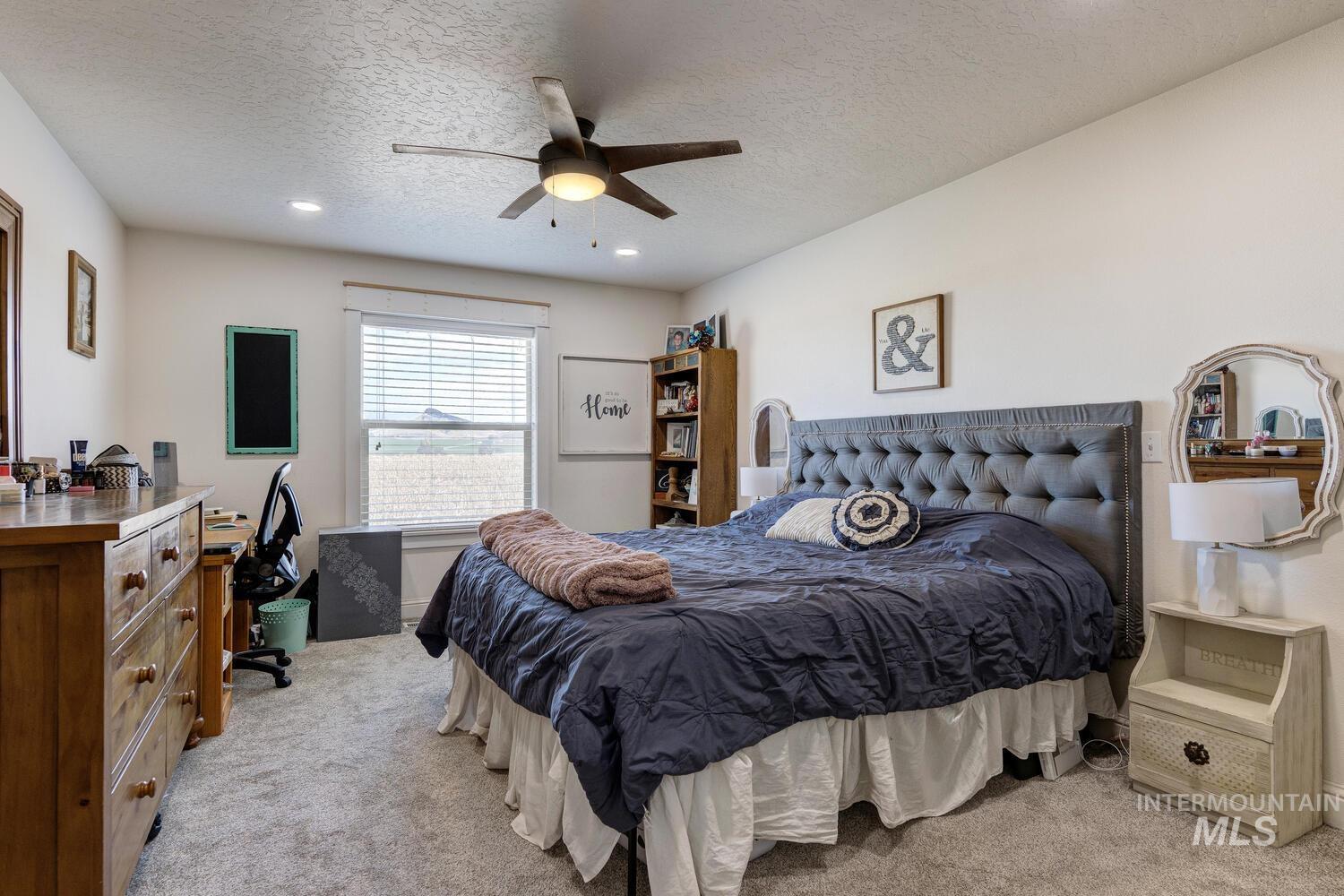 Bedroom featuring light colored carpet, a textured ceiling, ceiling fan, and recessed lighting