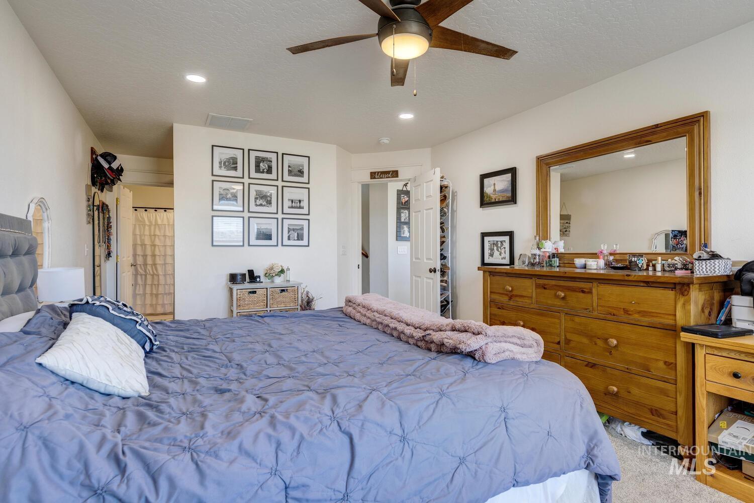 Bedroom with ceiling fan, carpet floors, recessed lighting, and a textured ceiling