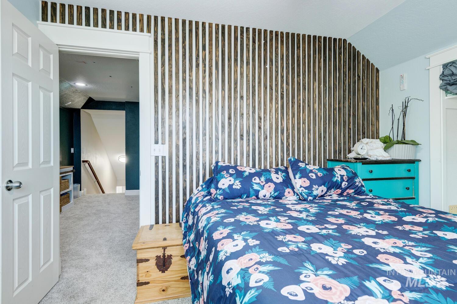 Carpeted bedroom featuring baseboards