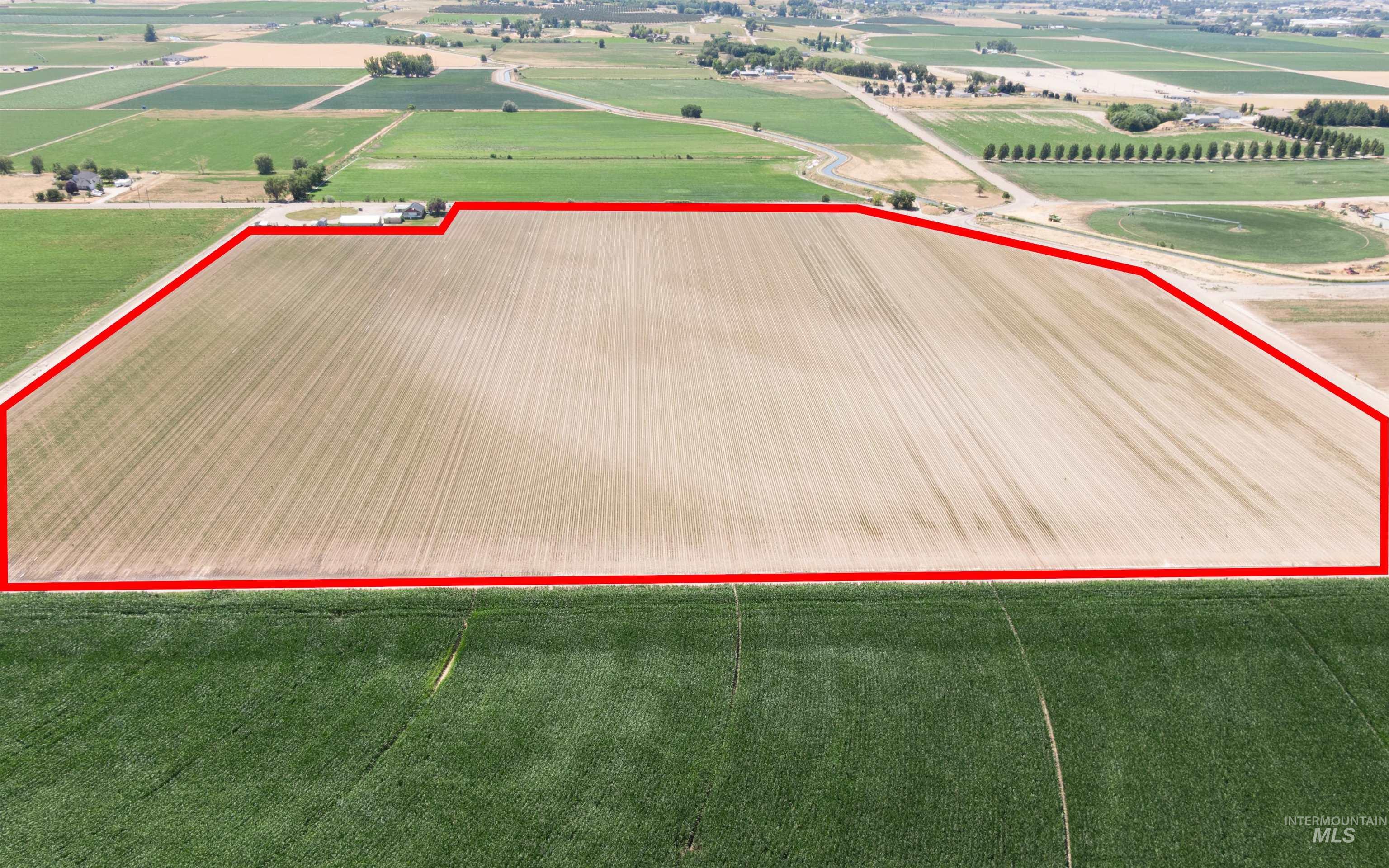 Overview of rural landscape featuring extensive farmland and property parcel outlined