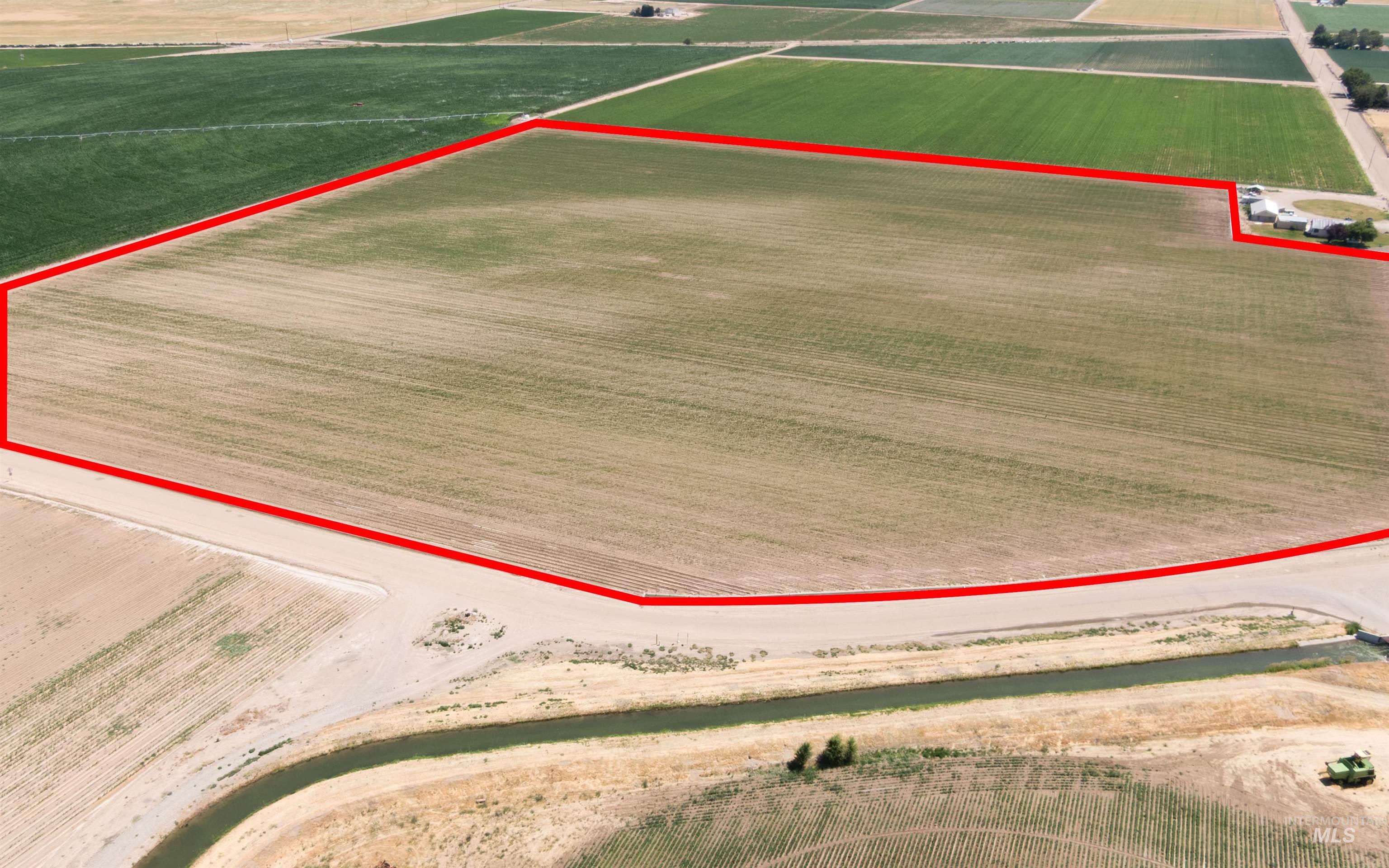 Overview of rural landscape with rows of crops and property parcel outlined