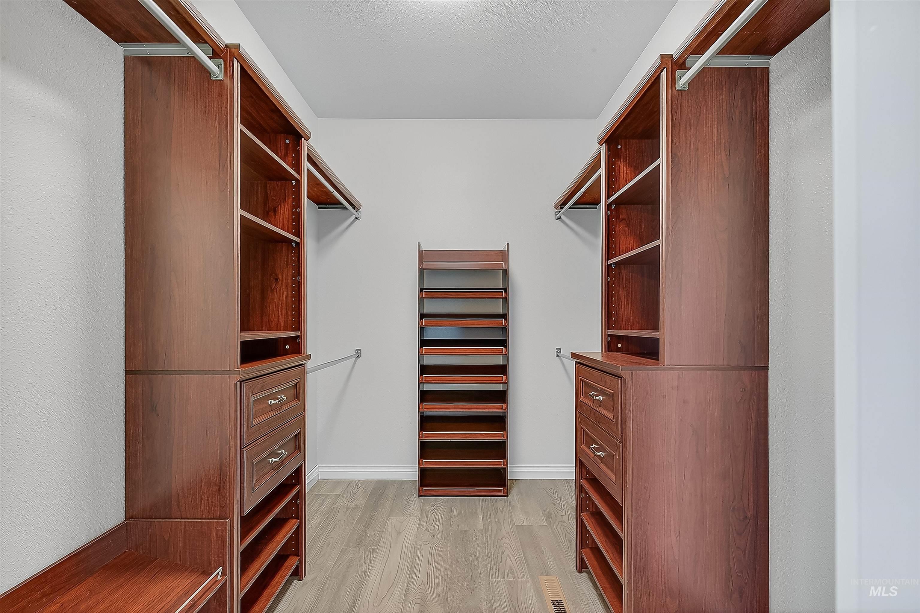 Spacious closet with light wood-type flooring