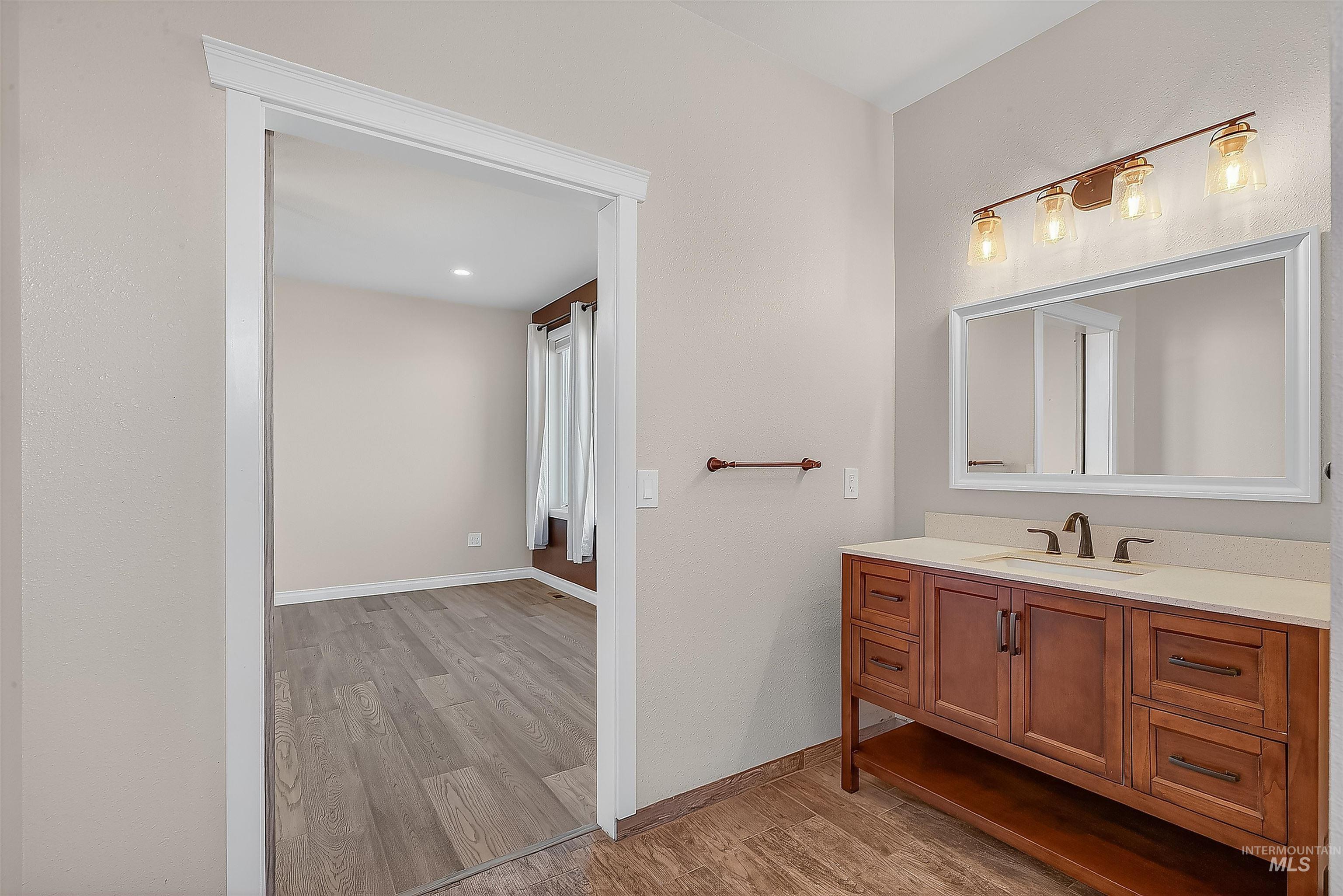 Bathroom featuring vanity and light wood finished floors