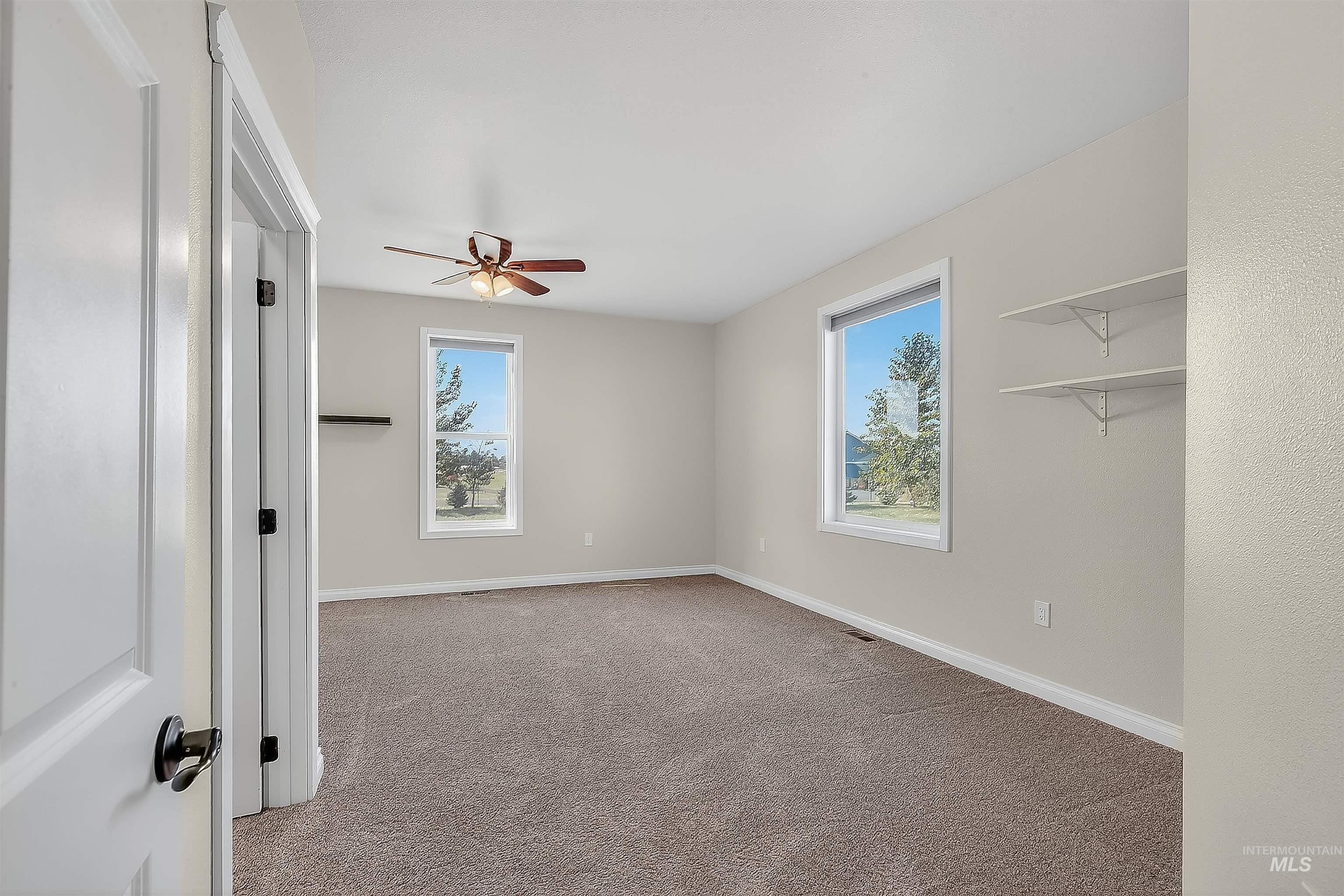Unfurnished bedroom featuring light colored carpet and a ceiling fan