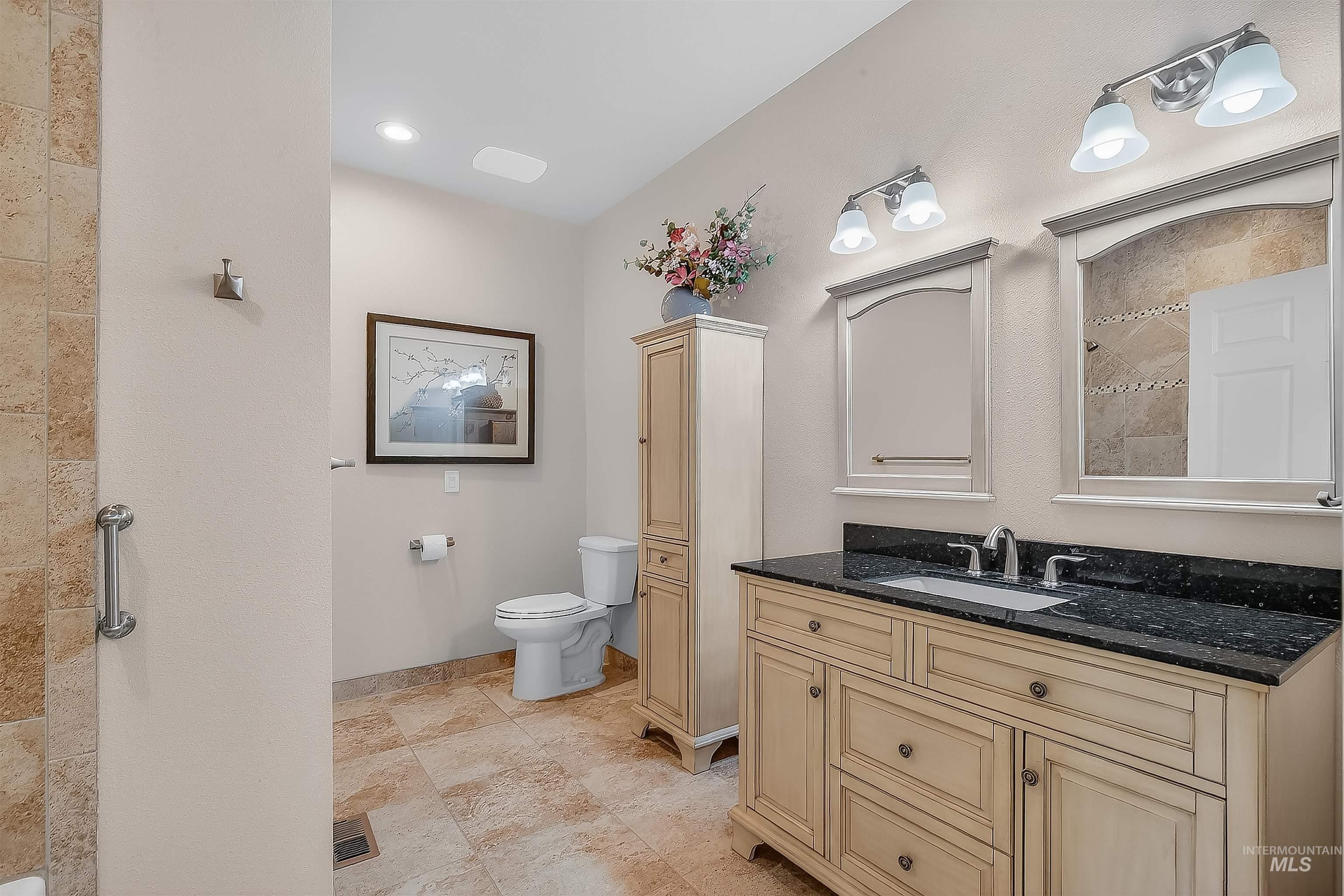 Bathroom featuring vanity and tiled shower