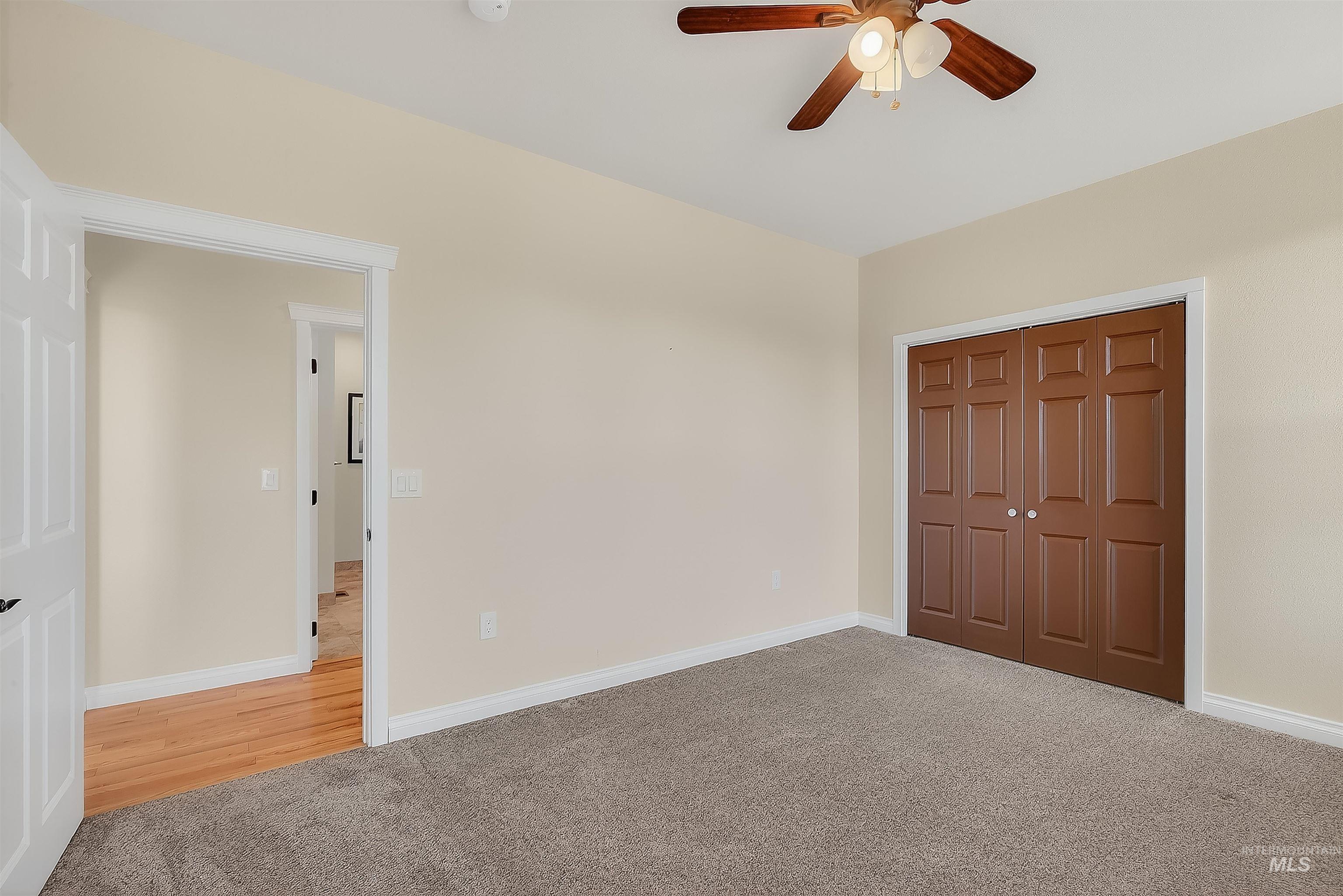 Unfurnished bedroom featuring carpet, a closet, and ceiling fan