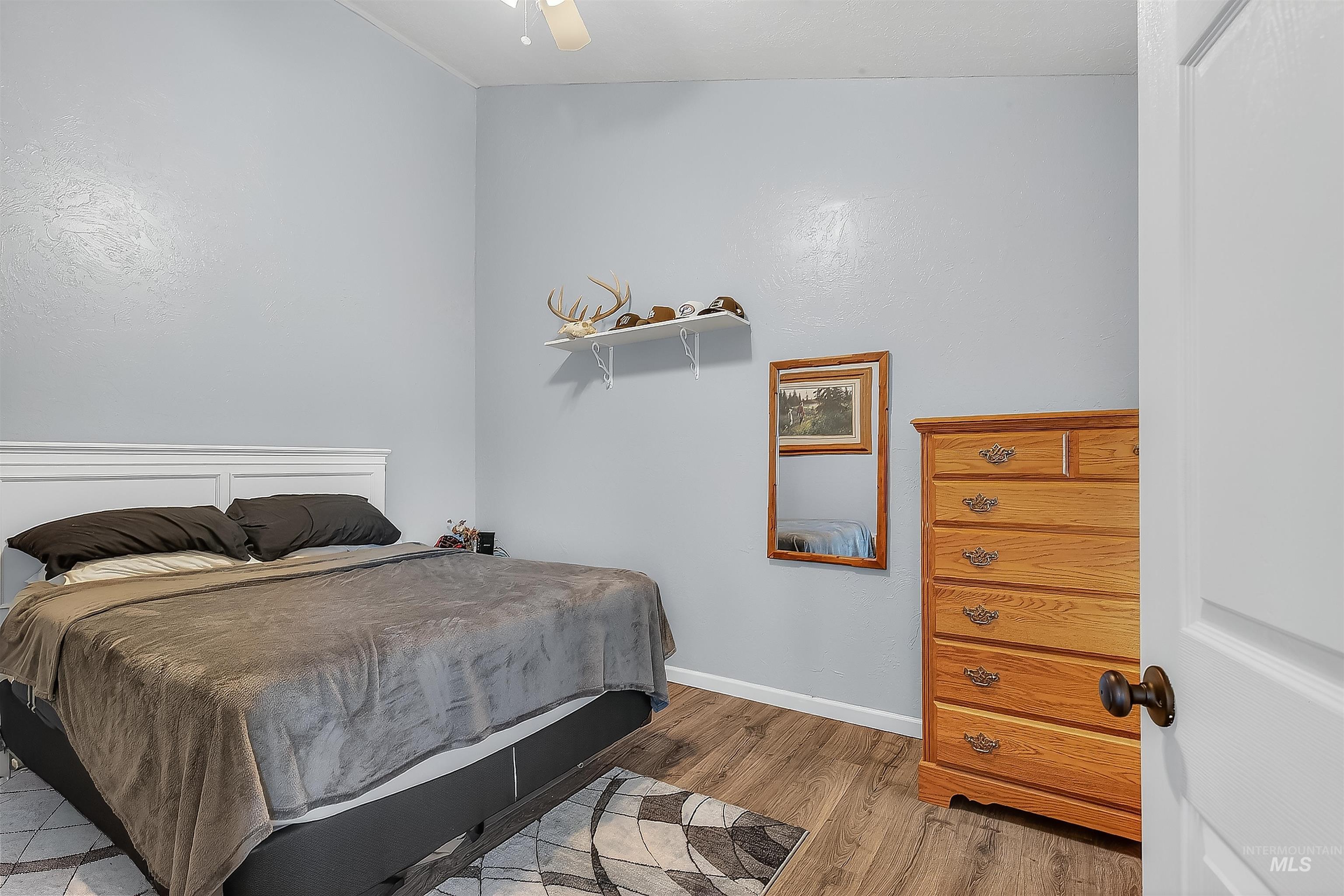 Bedroom with baseboards and light wood-type flooring