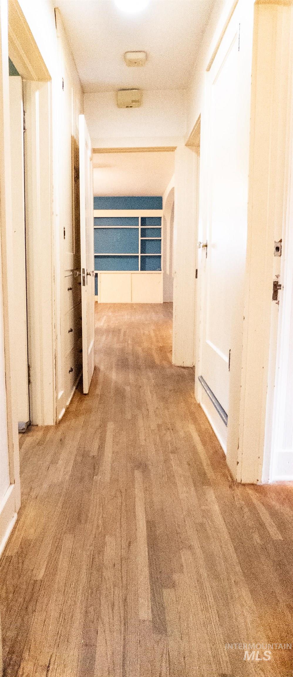 Hall with light wood-style flooring