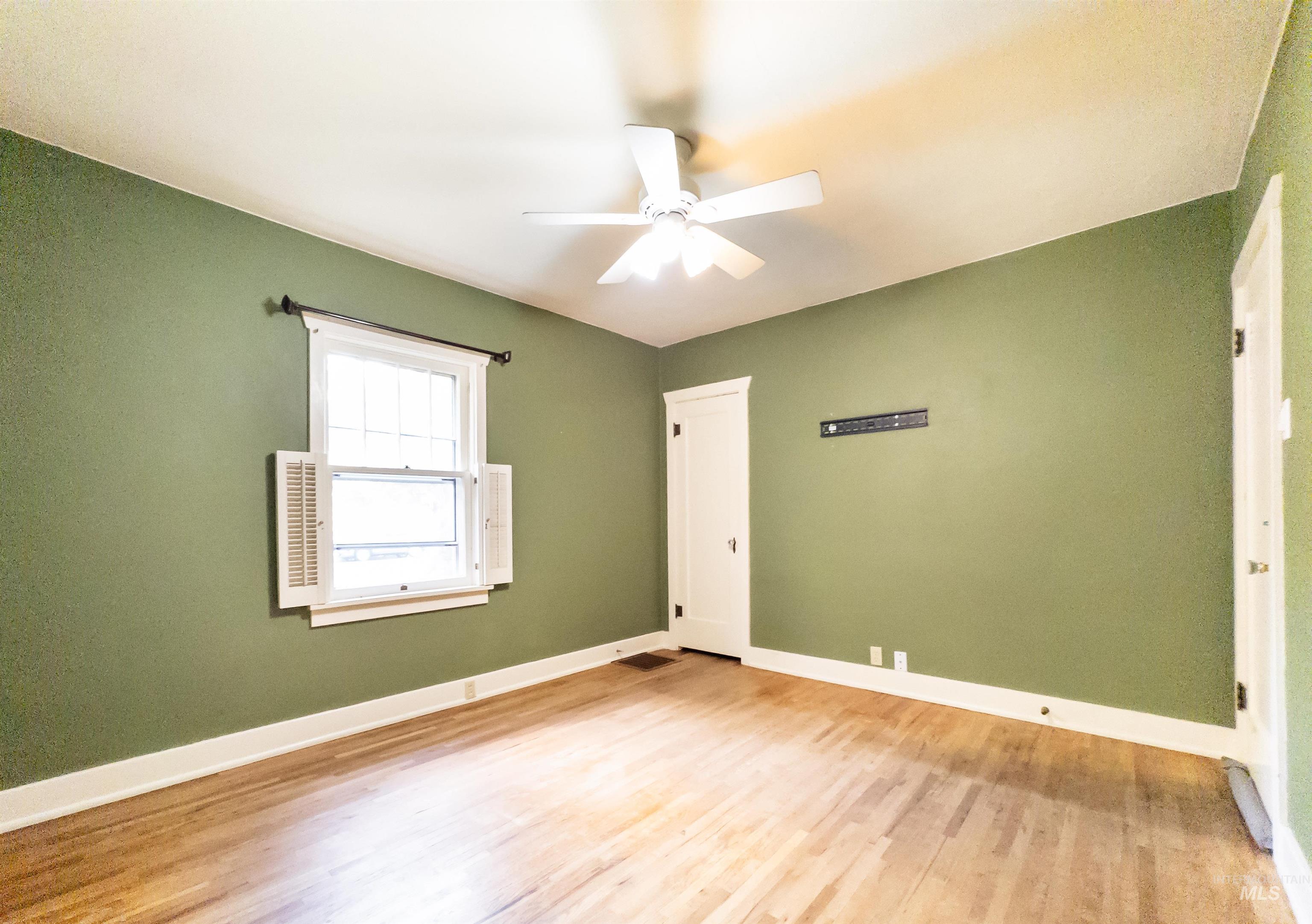 Unfurnished bedroom with wood finished floors and ceiling fan