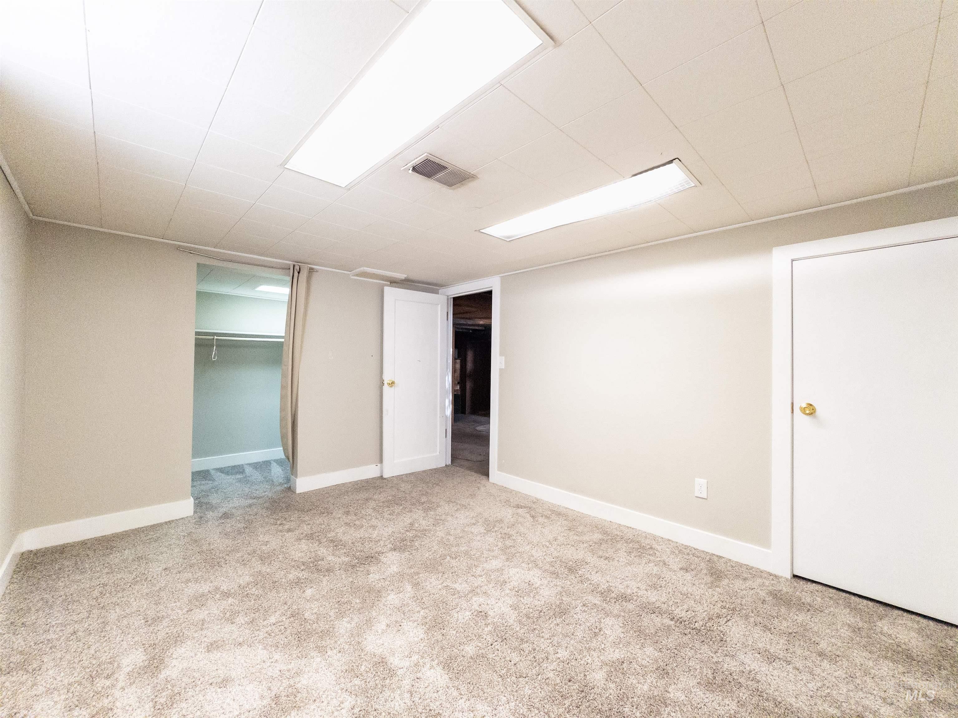 Unfurnished bedroom with a closet and light carpet