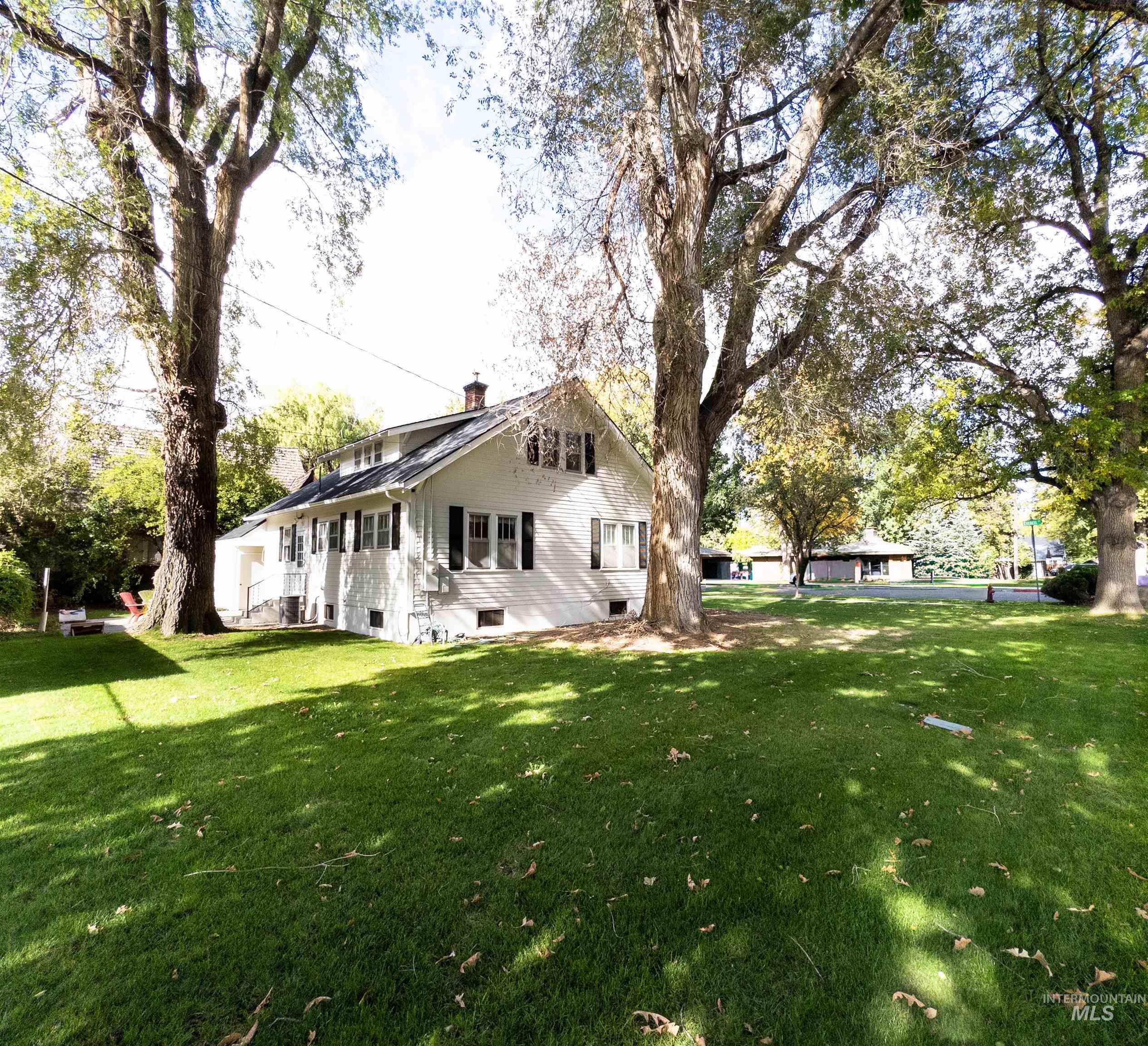 View of home's exterior featuring a yard and a chimney