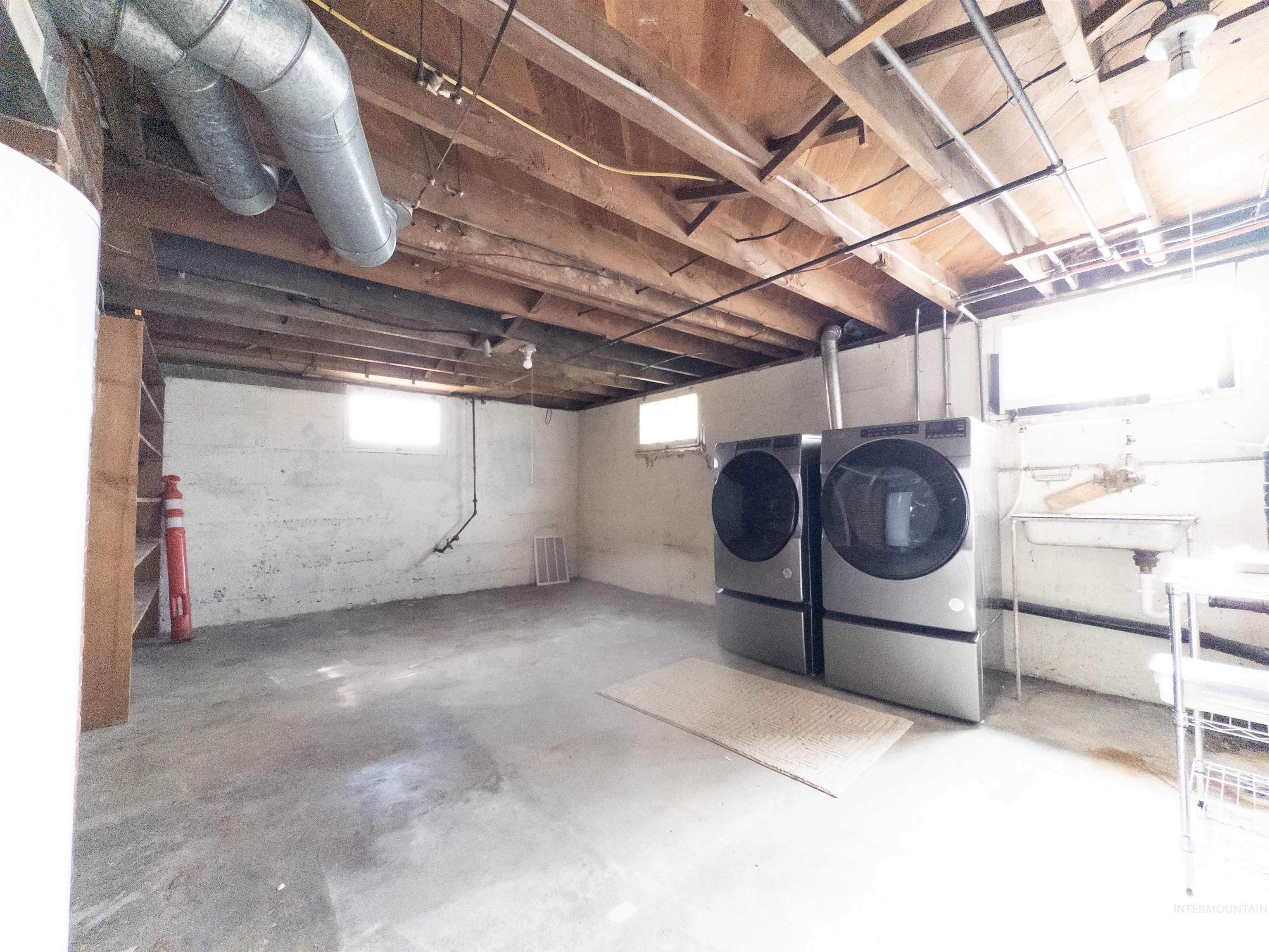 Below grade area with independent washer and dryer and a sink