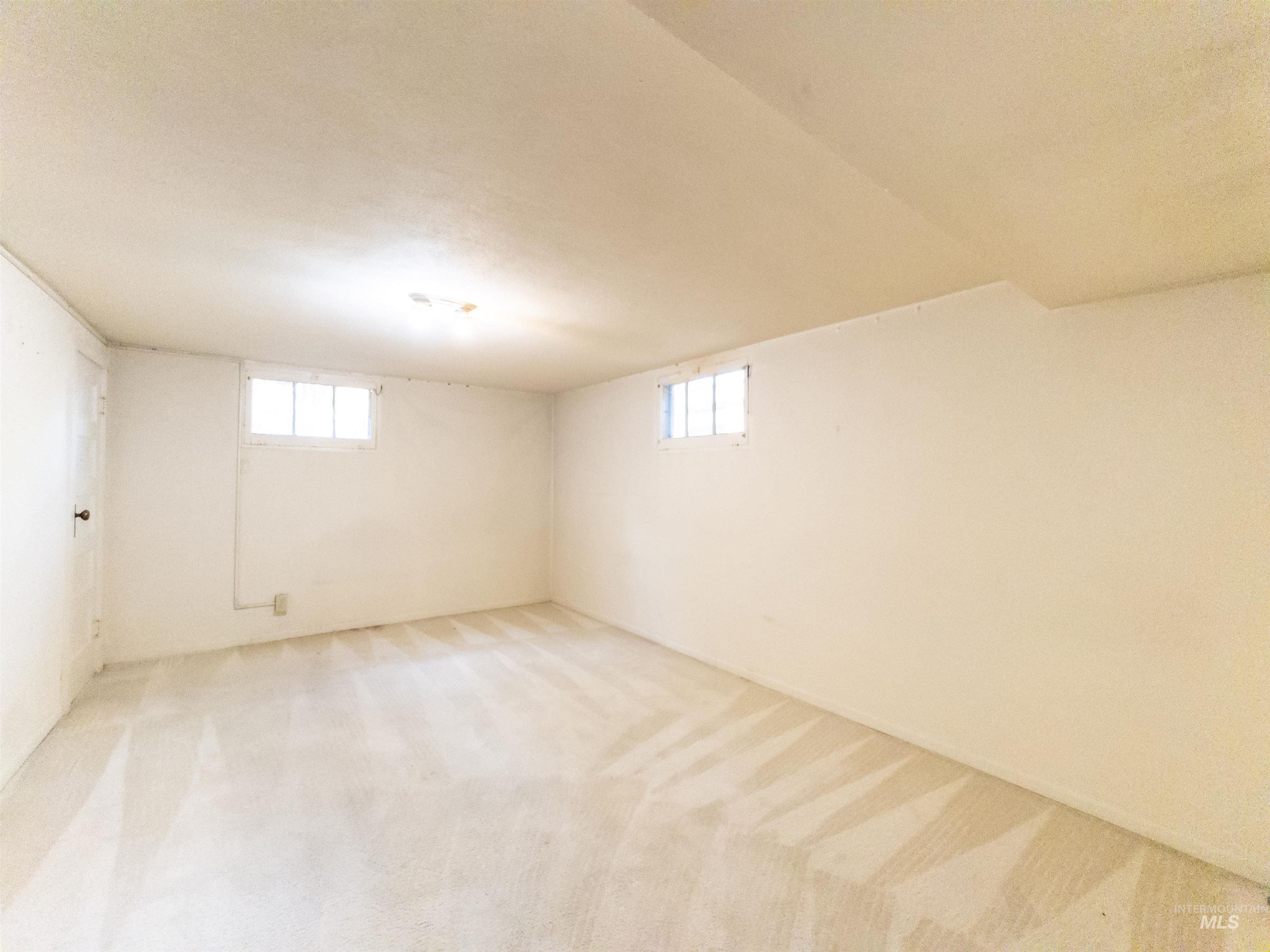 Below grade area with light colored carpet