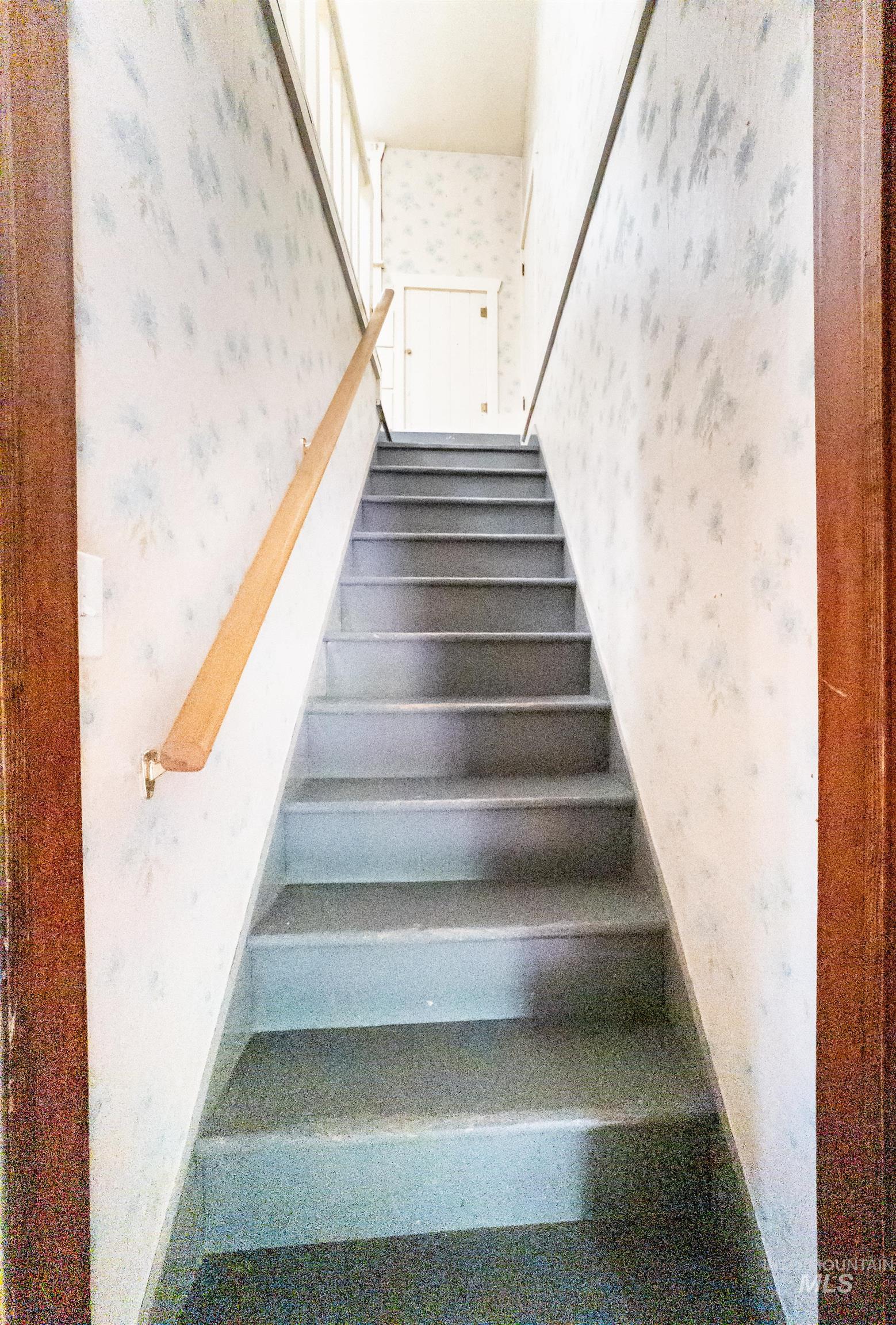 Staircase with wallpapered walls