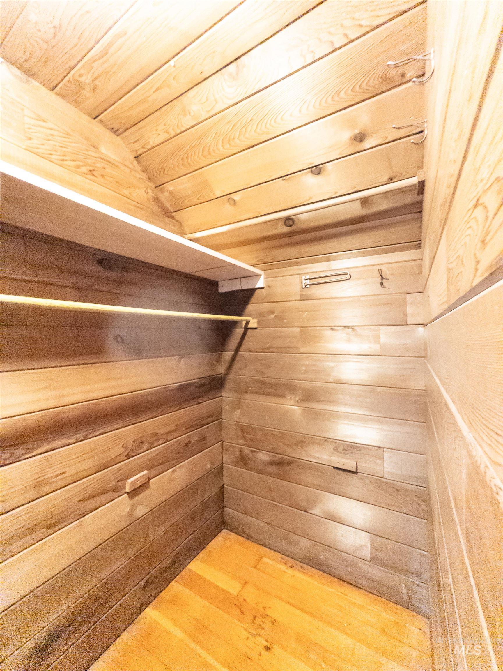Spacious closet with light wood finished floors