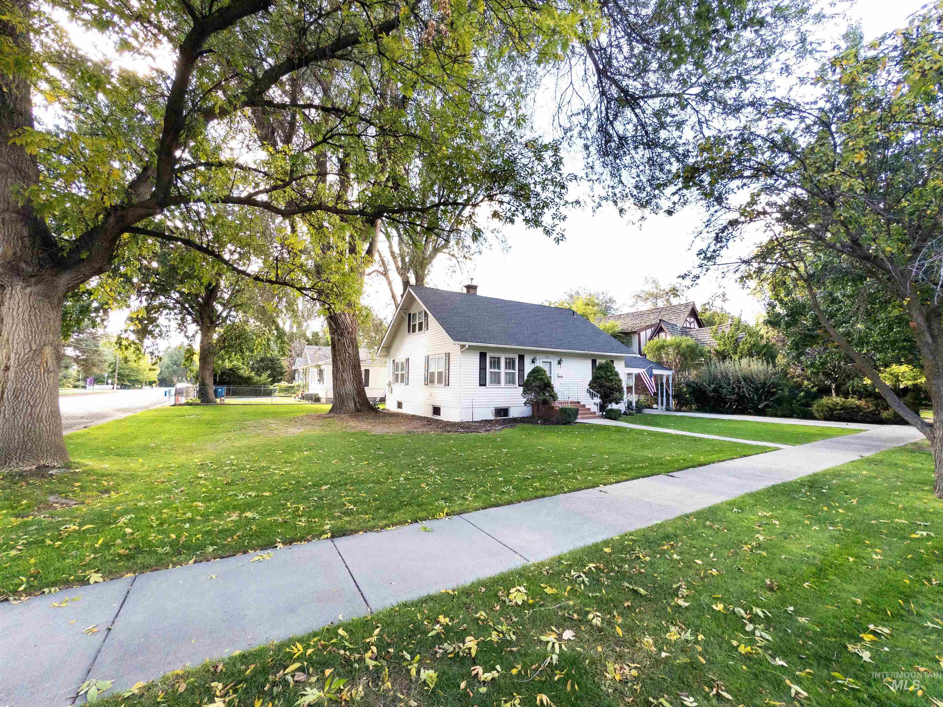 View of side of property with a yard and a chimney