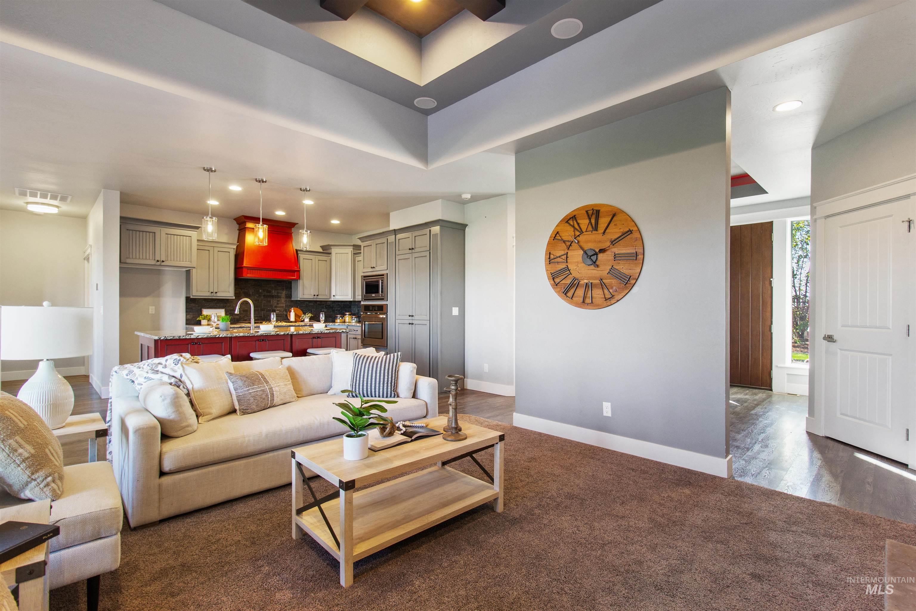 Living room featuring recessed lighting, dark colored carpet, and dark wood finished floors