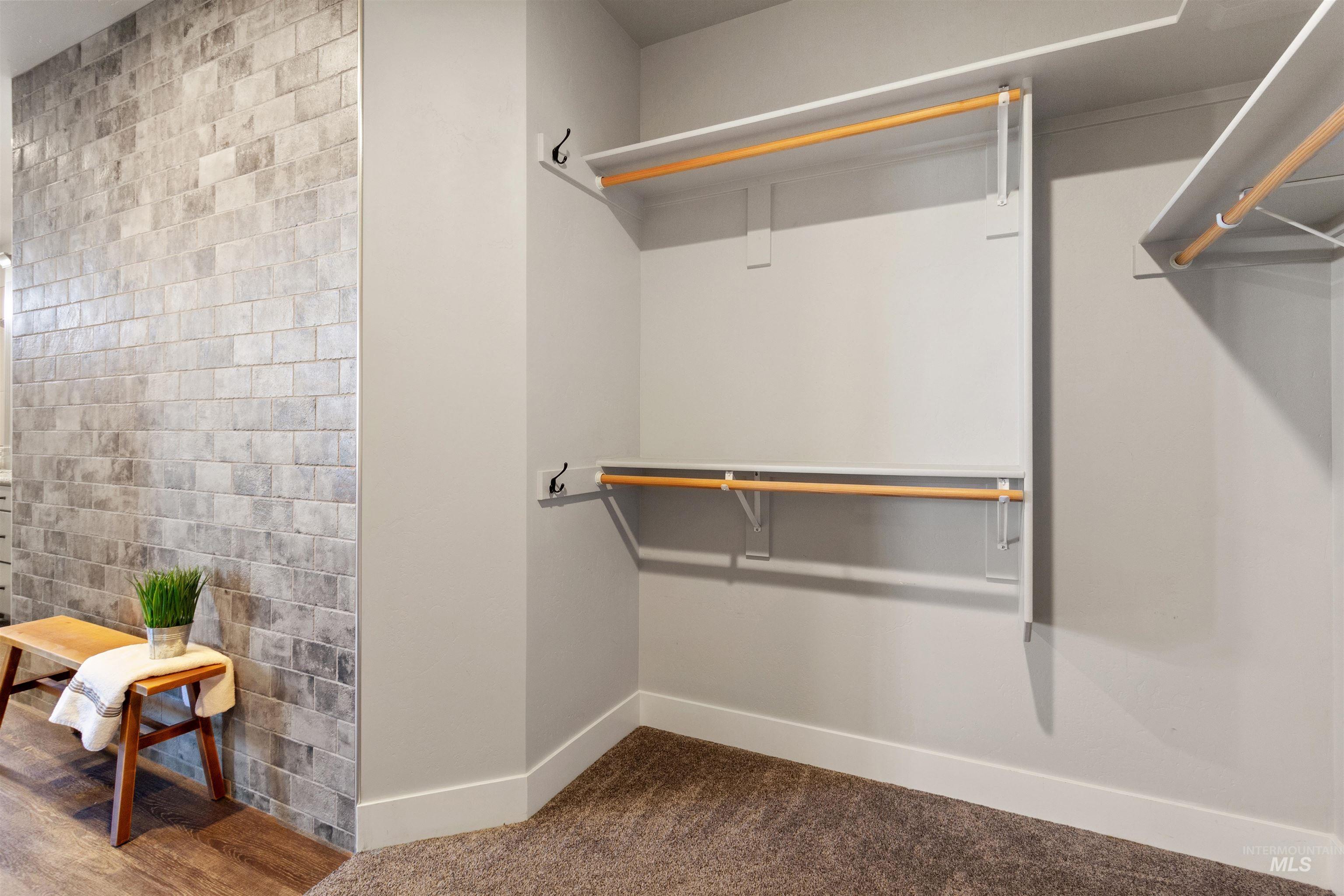Walk in closet with dark carpet