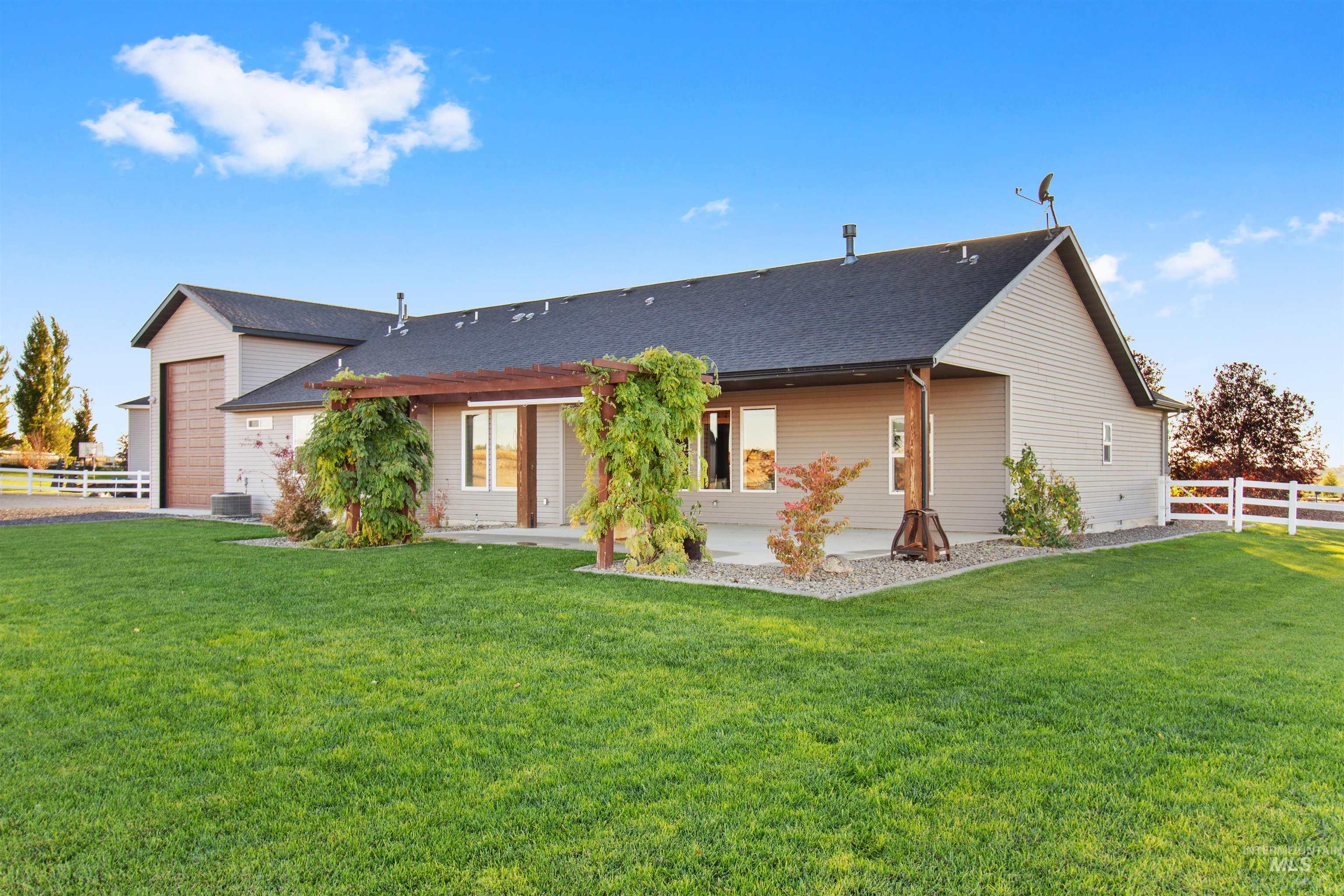 Back of property with a patio area and roof with shingles