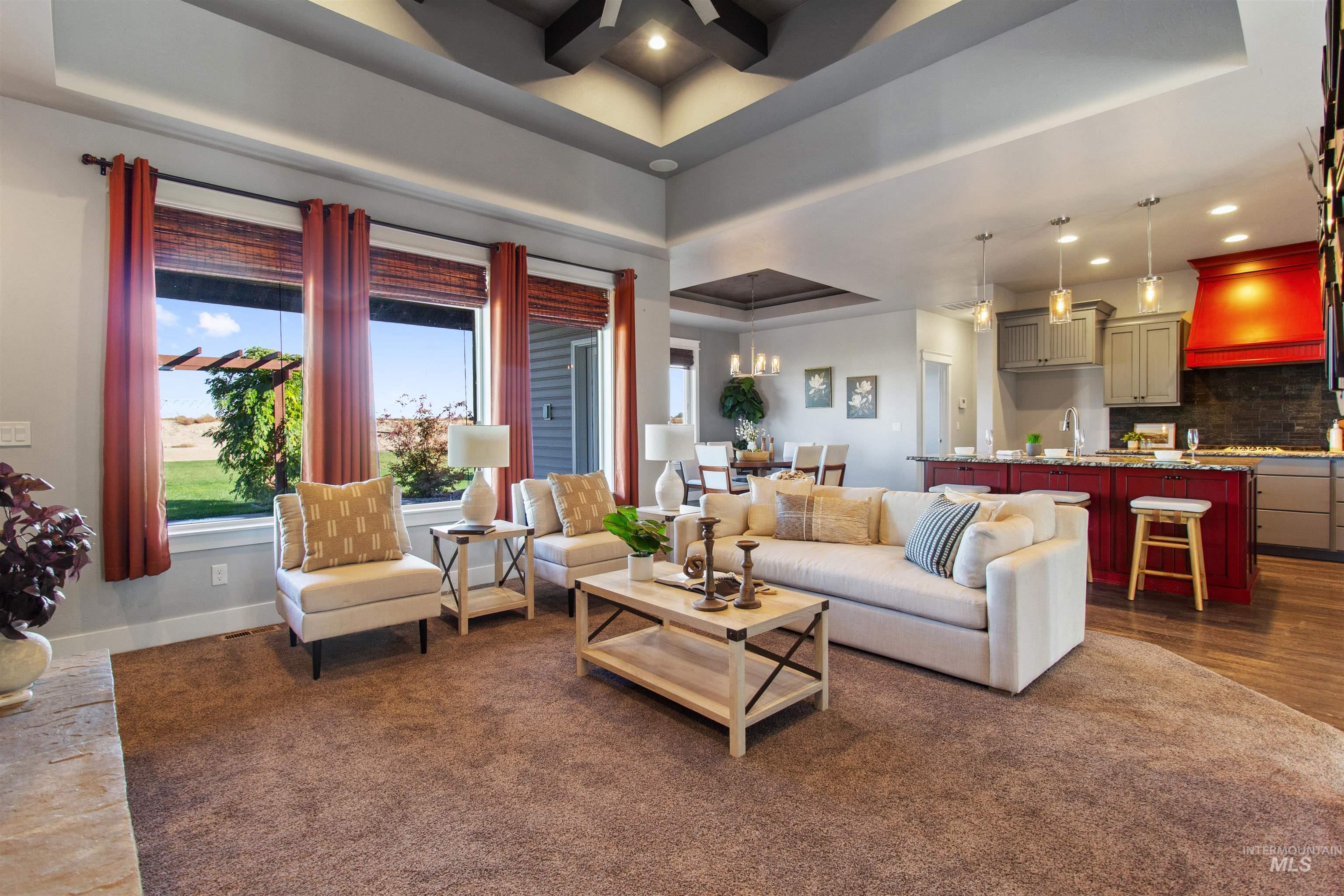 Living area featuring recessed lighting and a tray ceiling