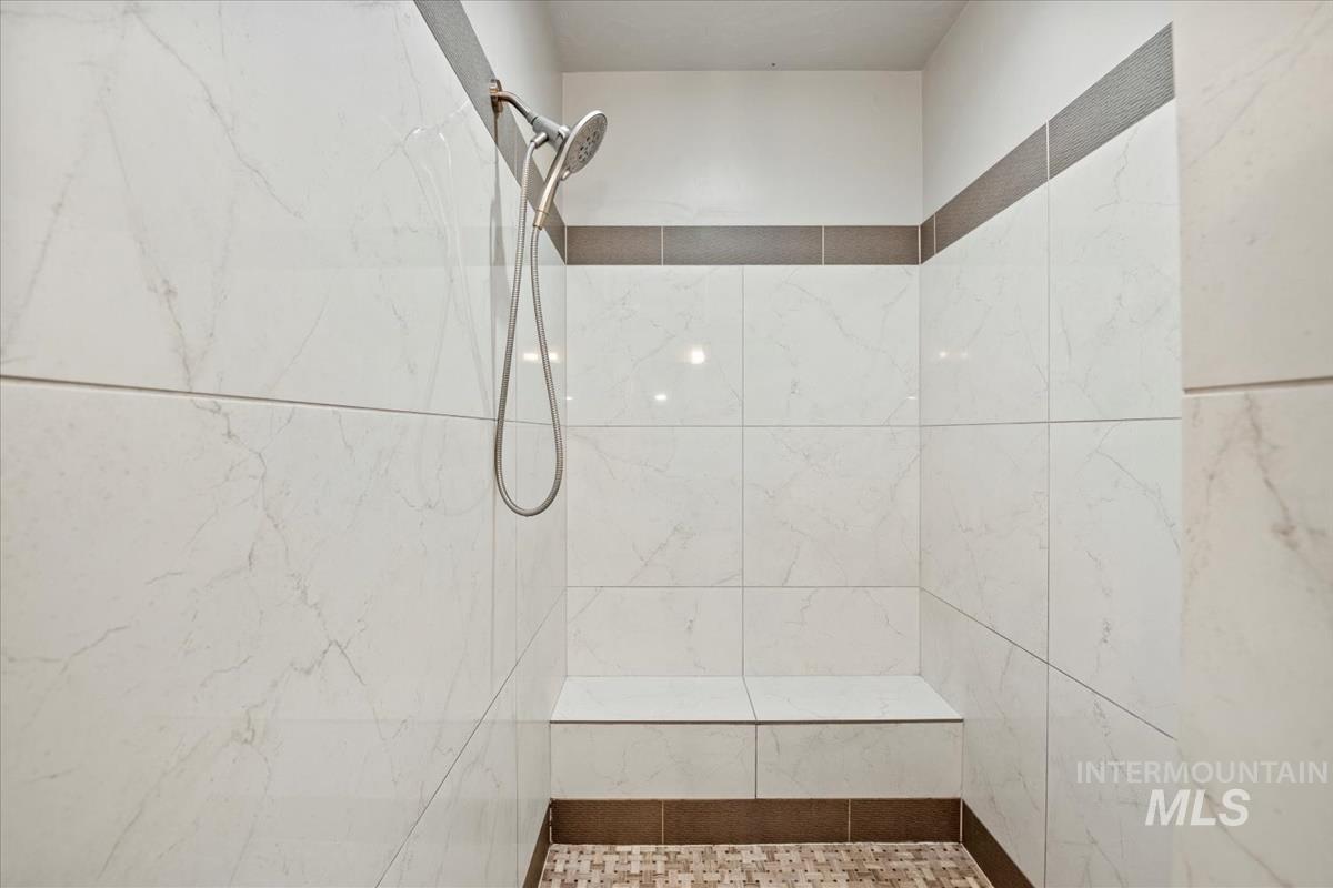Bathroom with a marble finish shower