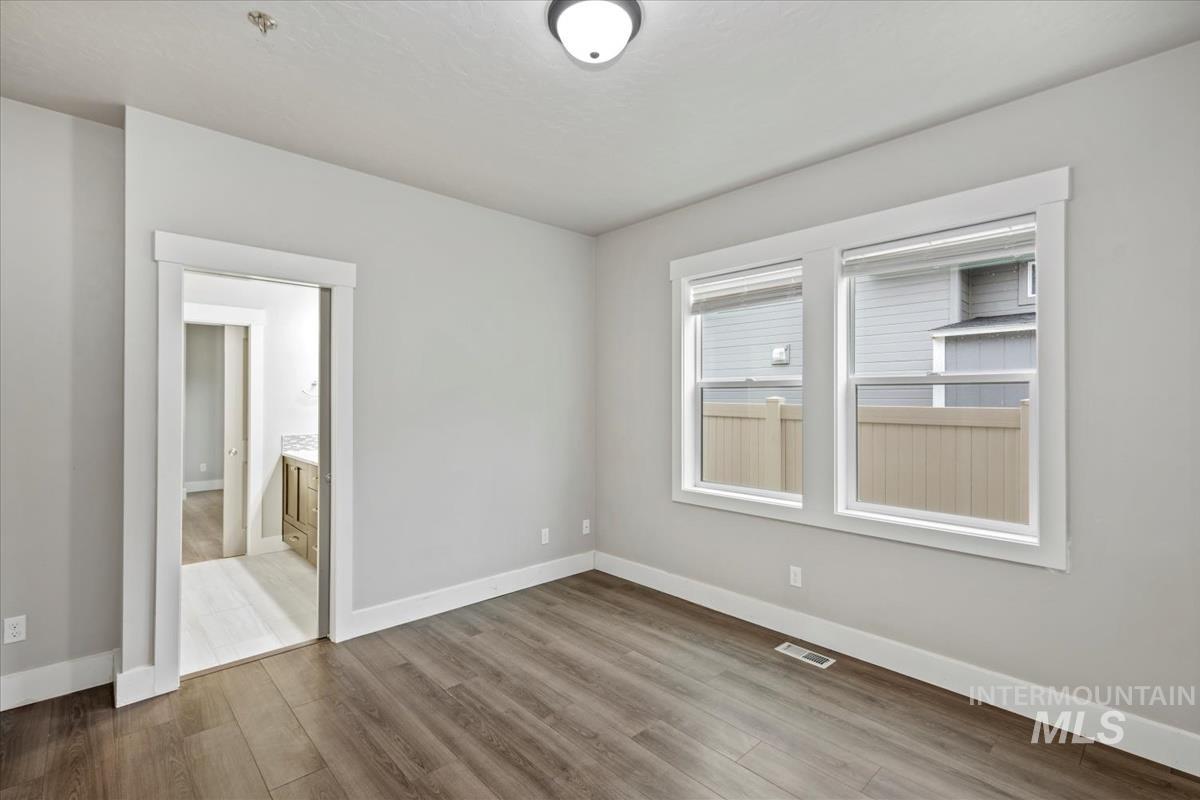 Empty room featuring baseboards and wood finished floors