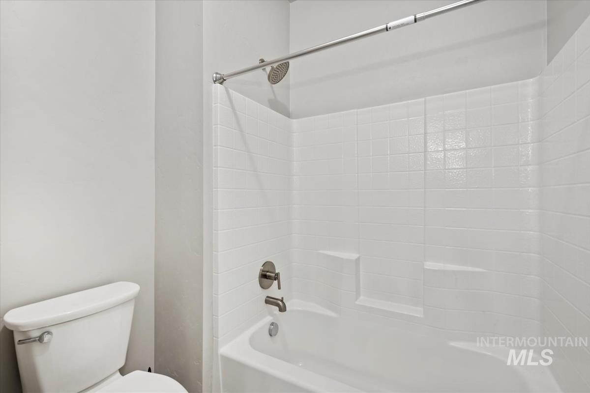 Full bath with shower / washtub combination and toilet
