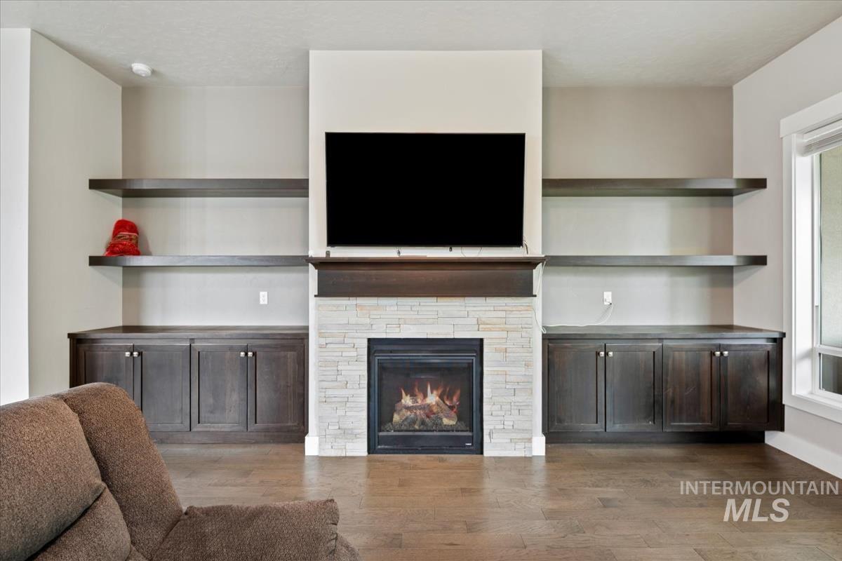 Living room featuring light wood finished floors and a fireplace