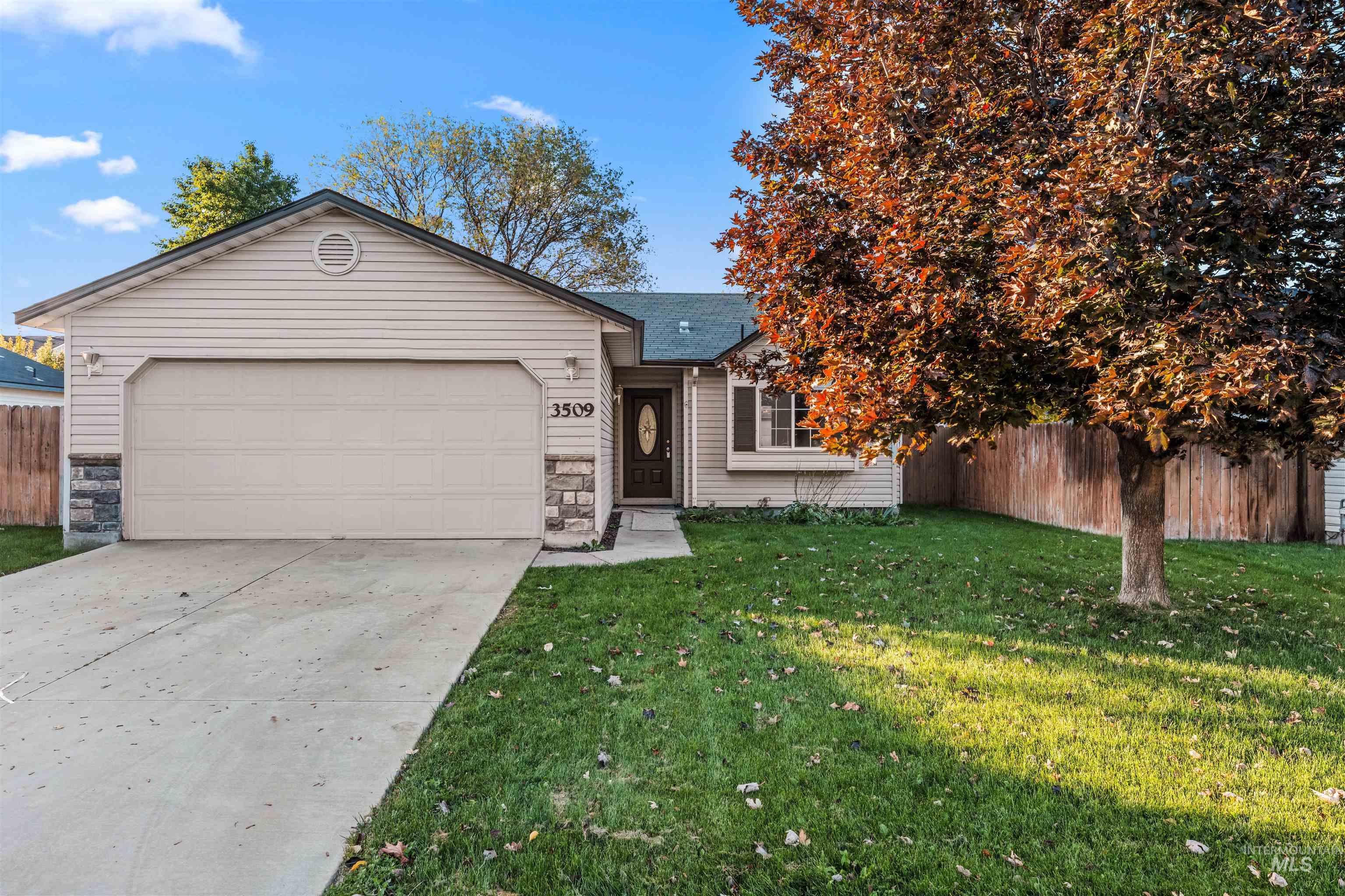 Ranch-style house with concrete driveway, a garage, stone siding, and roof with shingles