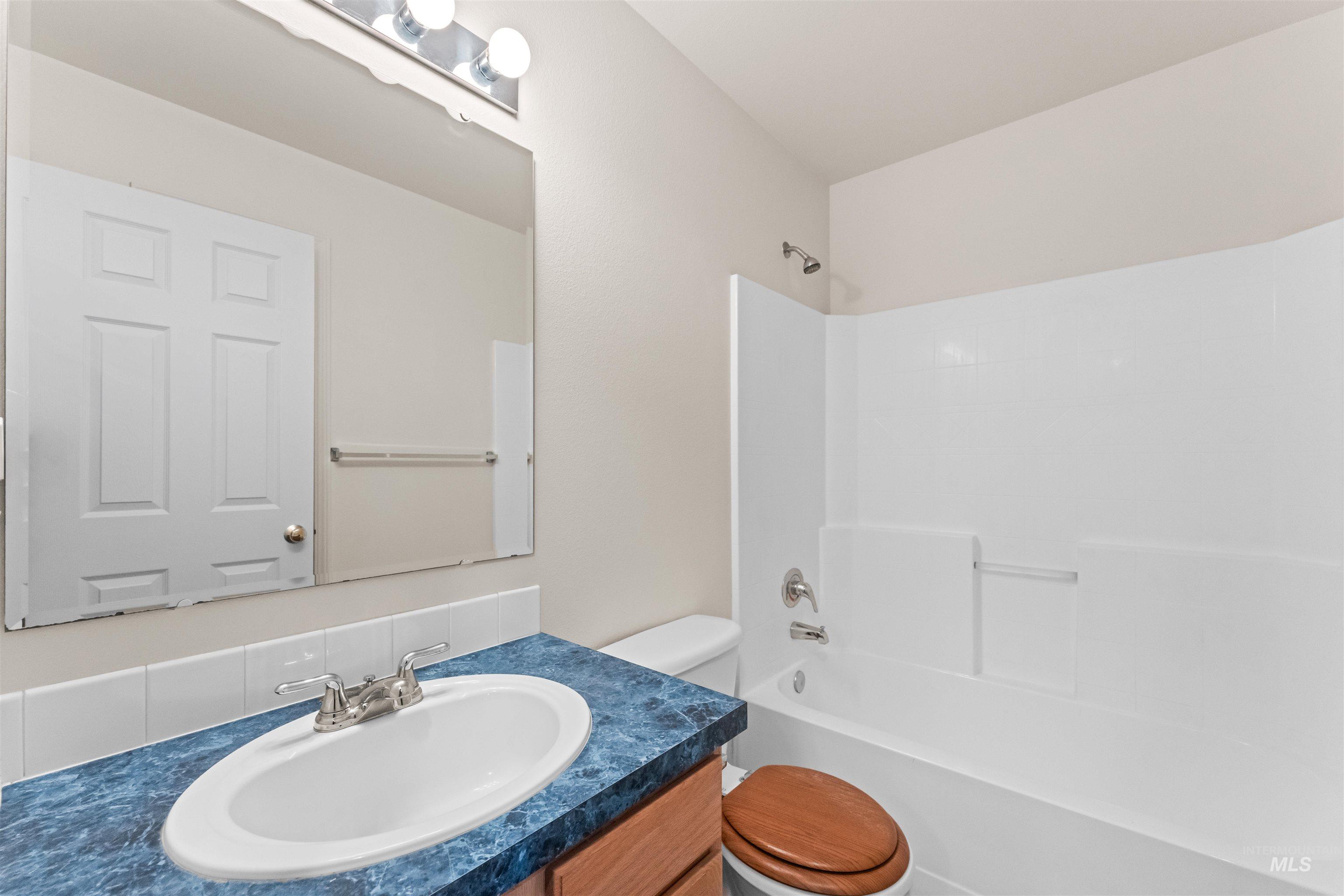 Bathroom featuring vanity and bathing tub / shower combination