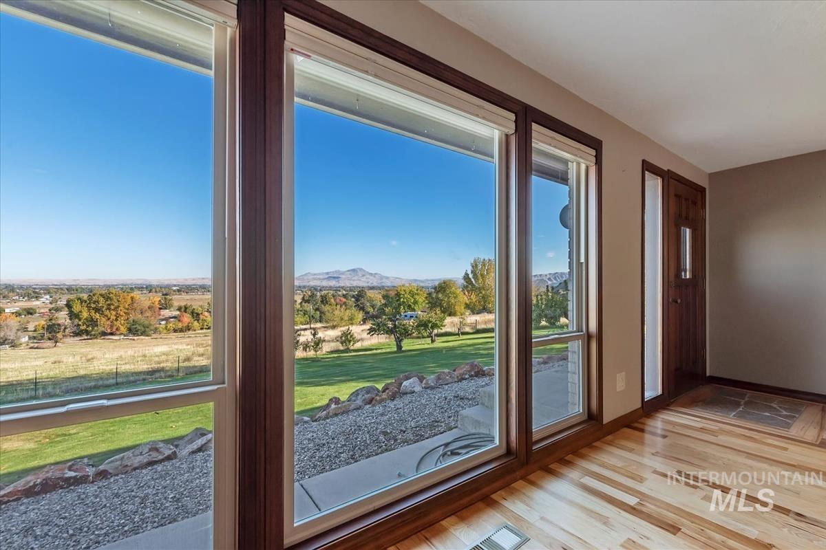 Entryway featuring wood finished floors and a mountain view