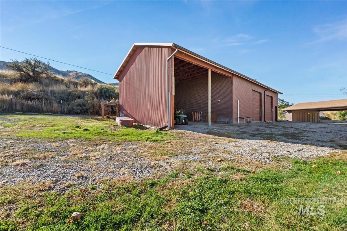 View of pole building featuring a yard