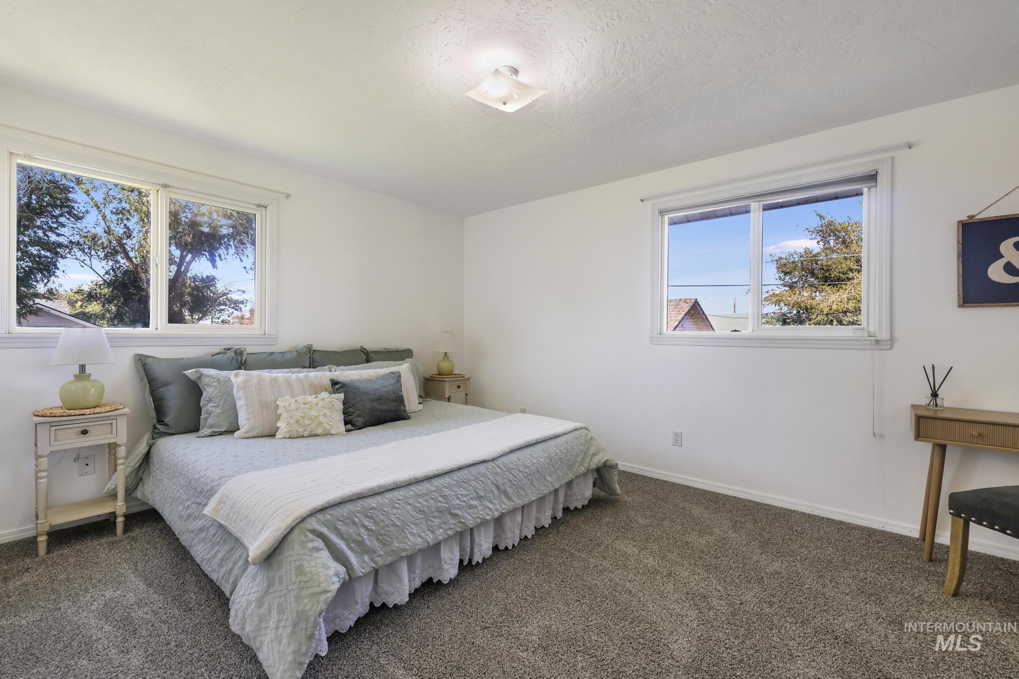 Bedroom featuring carpet flooring and a textured ceiling
