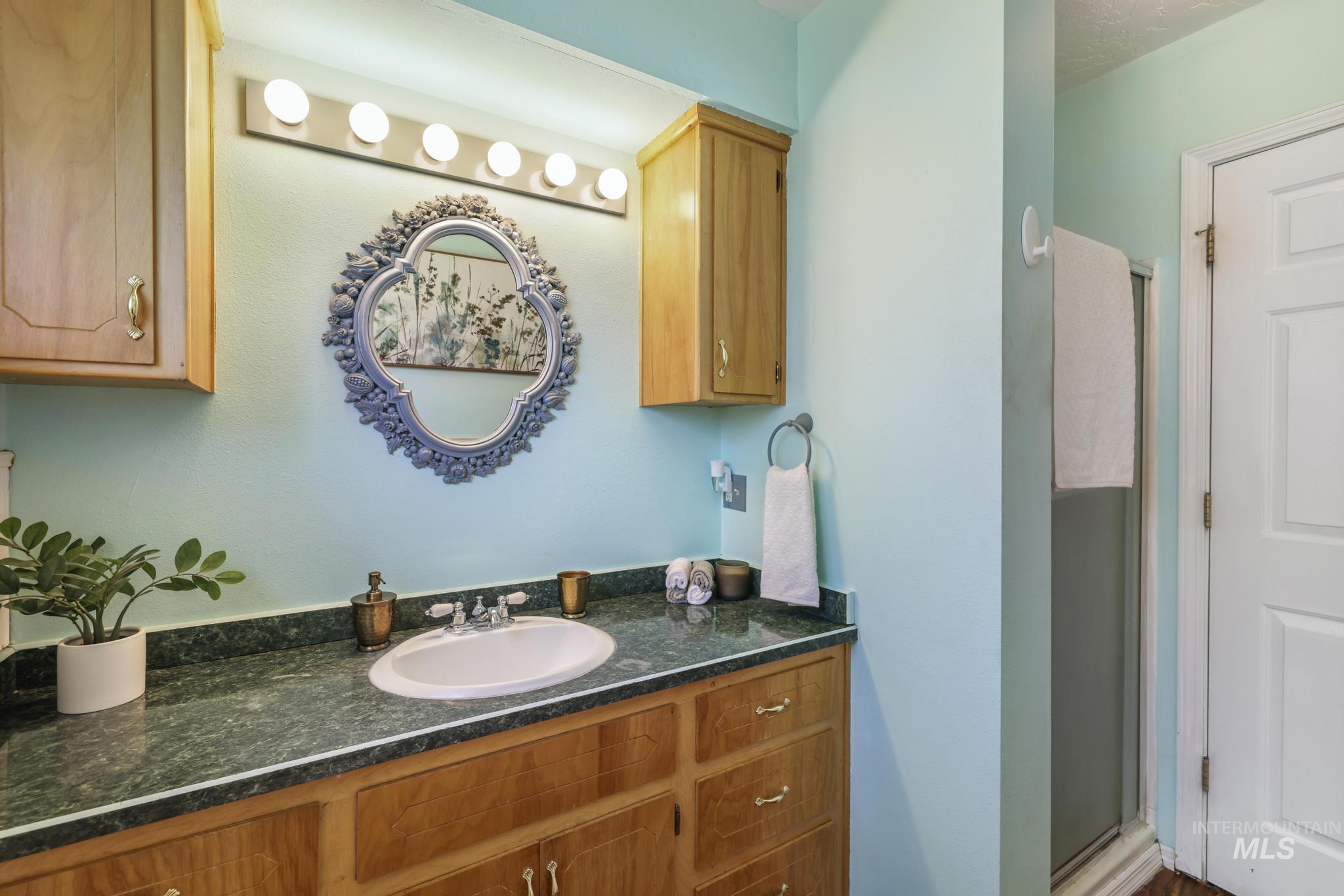 Bathroom with vanity and a shower stall