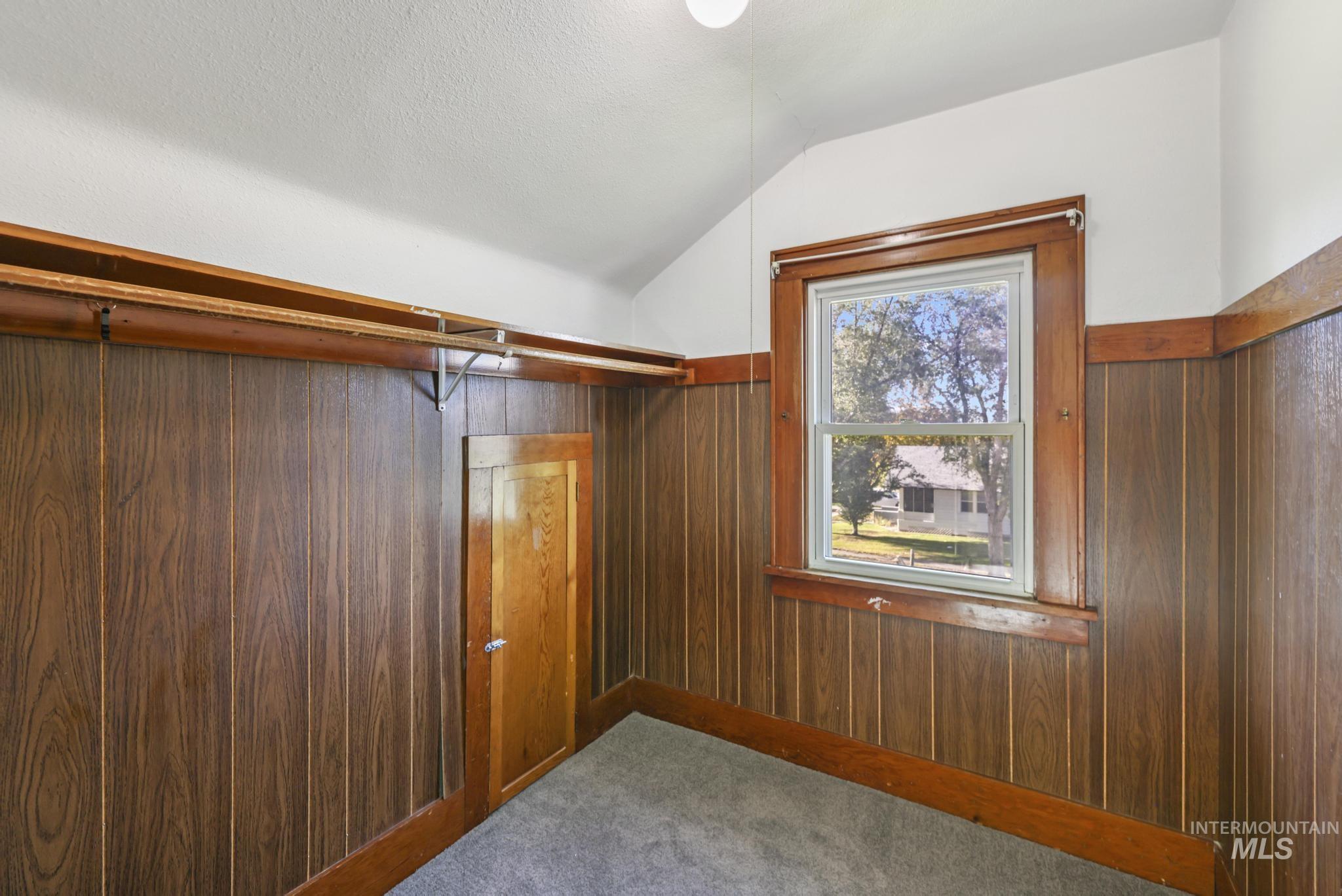 Spacious closet with vaulted ceiling and carpet