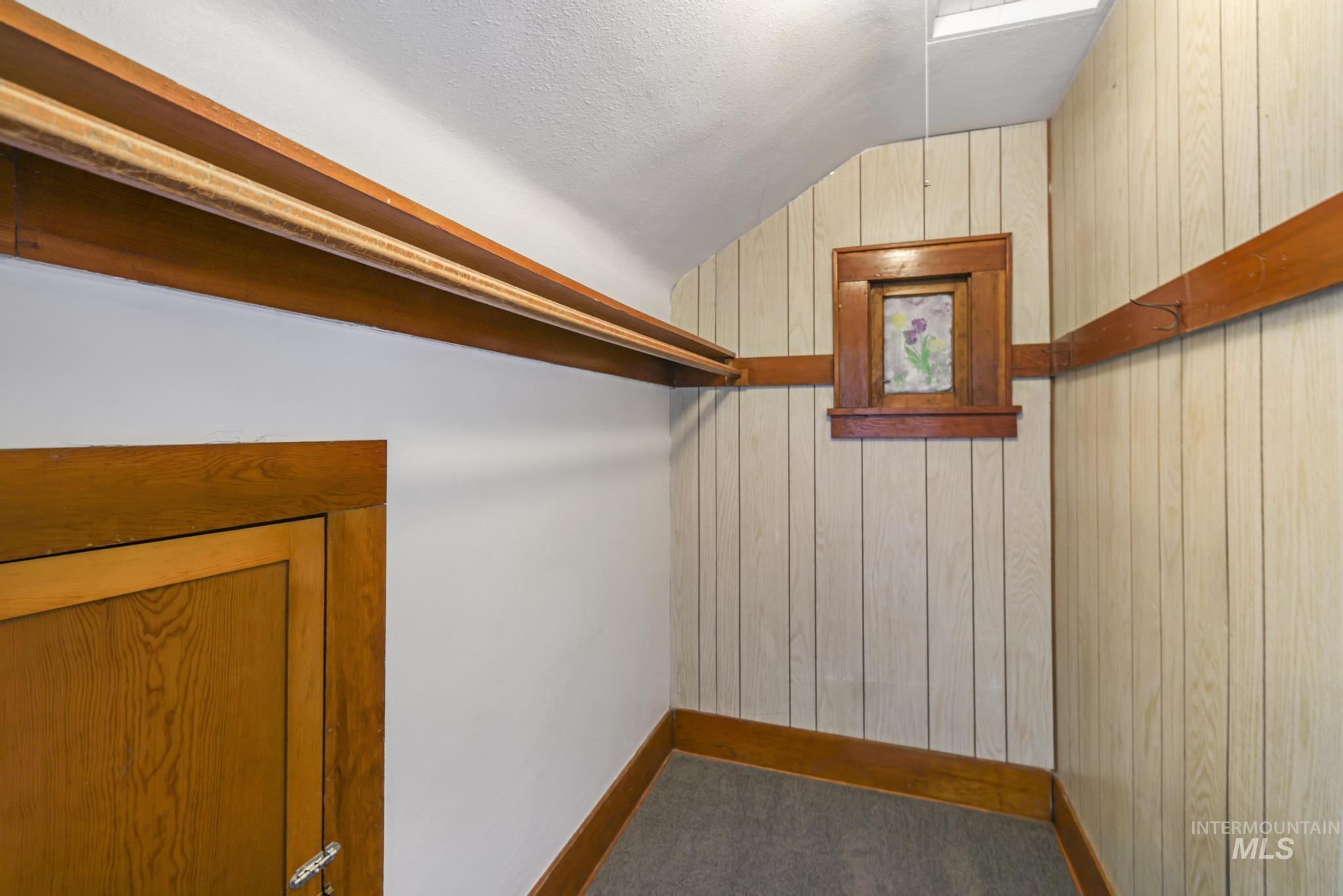 Walk in closet featuring vaulted ceiling