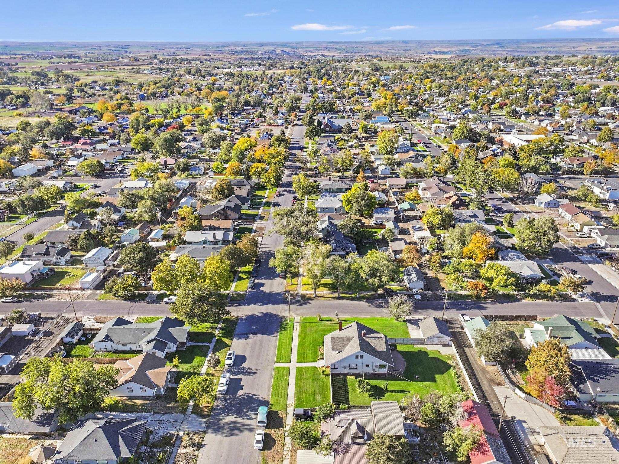 Aerial view of property and surrounding area with nearby suburban area
